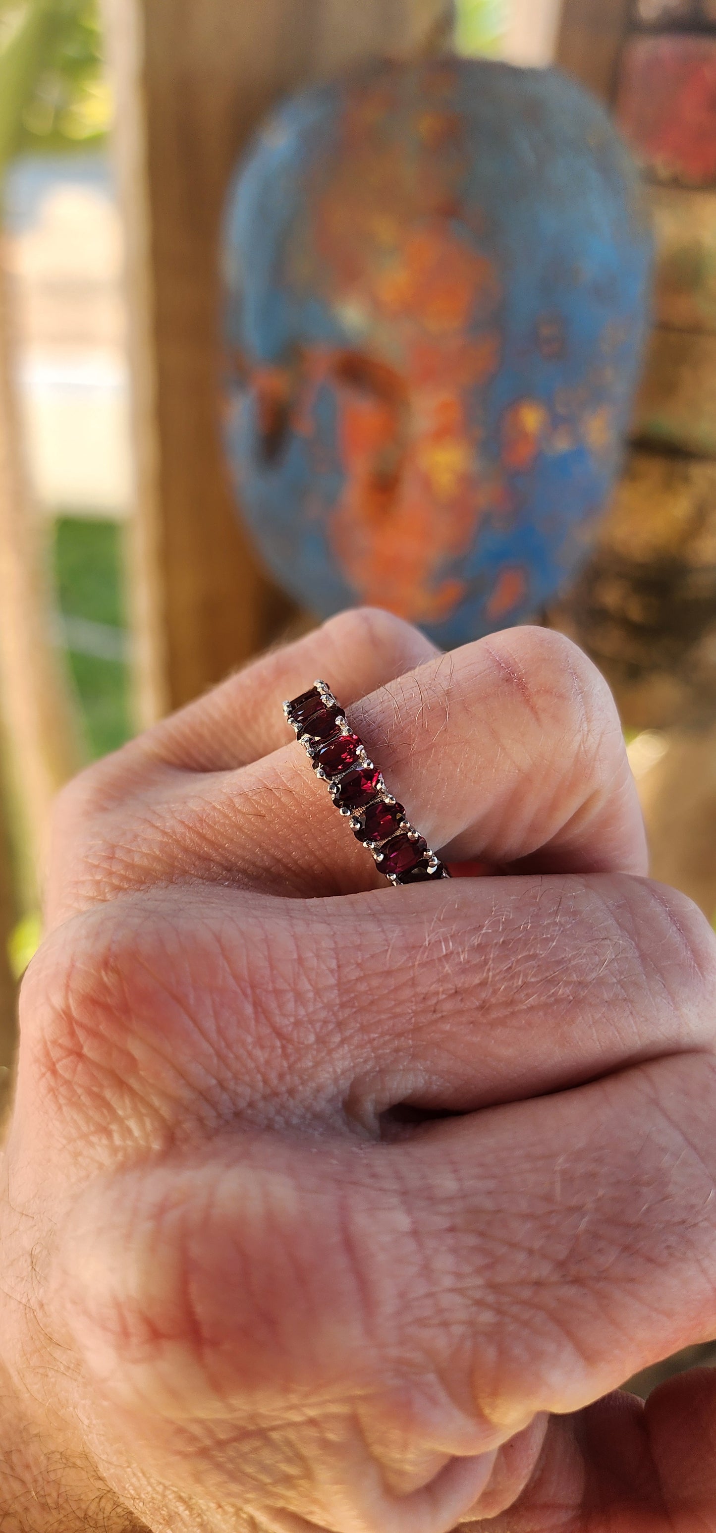 This sterling silver full eternity ring is a dazzling display of deep, rich purple rhodolite garnets, meticulously claw-set in an endless circle of brilliance.