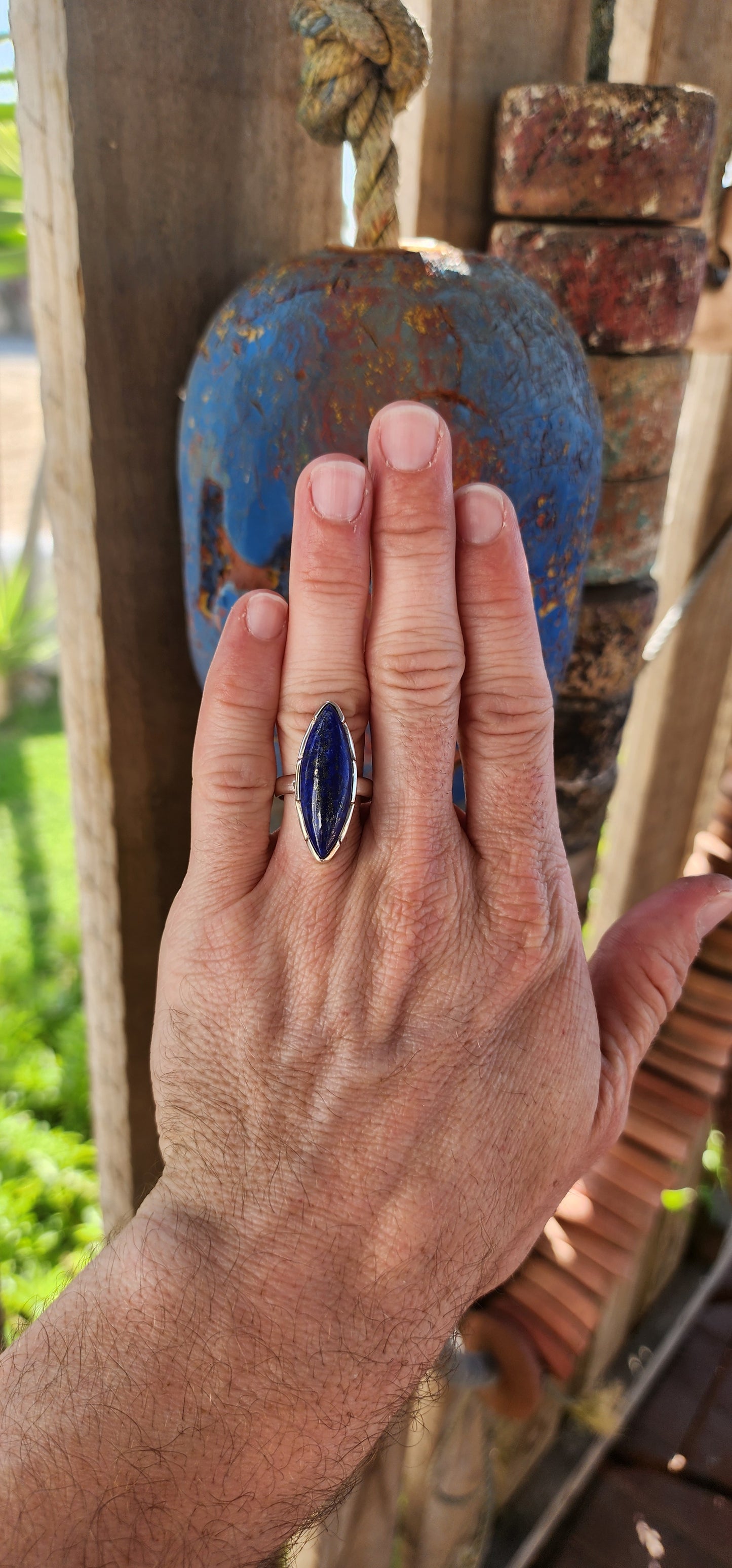 This stunning artisan-crafted statement ring is a true embodiment of bold elegance and refined craftsmanship. The piece is crafted from solid sterling silver, showcasing a magical, marquise cut Lapis Lazuli cabochon.
