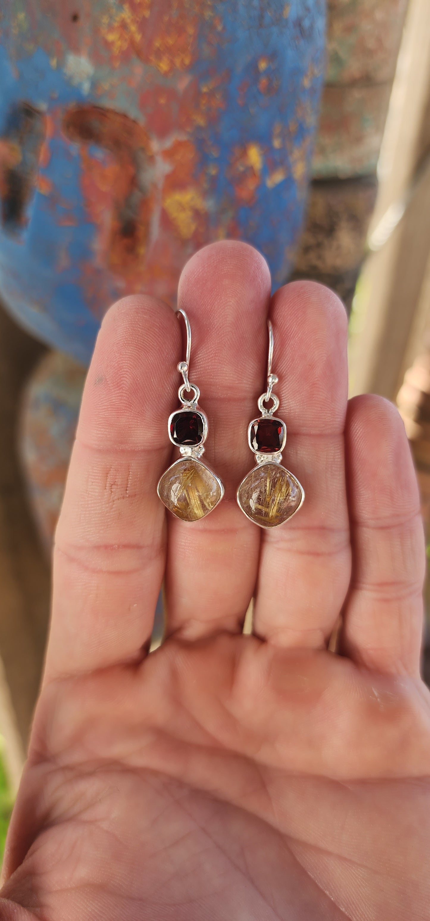 These sterling silver drop earrings are the perfect fusion of fire and earth, a mesmerizing dance between passion and mystique.