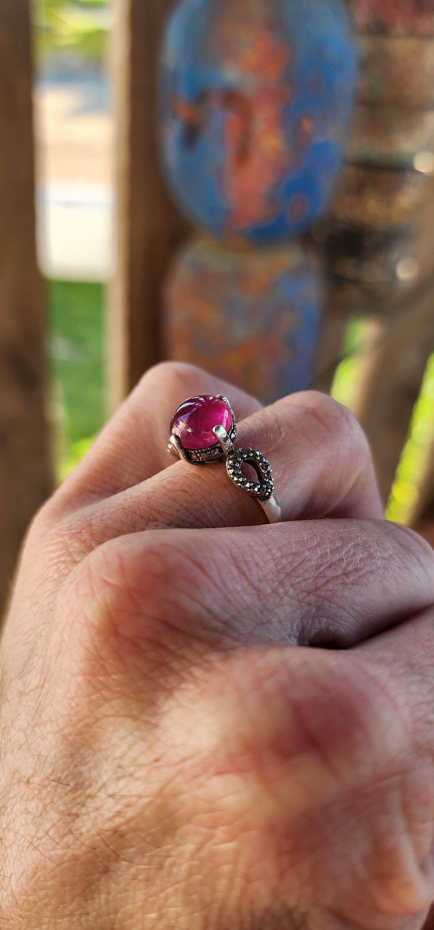 The Enchanted Rose" – A Ring of Timeless Elegance.
This sterling silver and rubellite tourmaline cabochon solitaire ring, affectionately named "The Enchanted Rose," is a spellbinding creation, whispering tales of romance, mystery, and celestial beauty.
