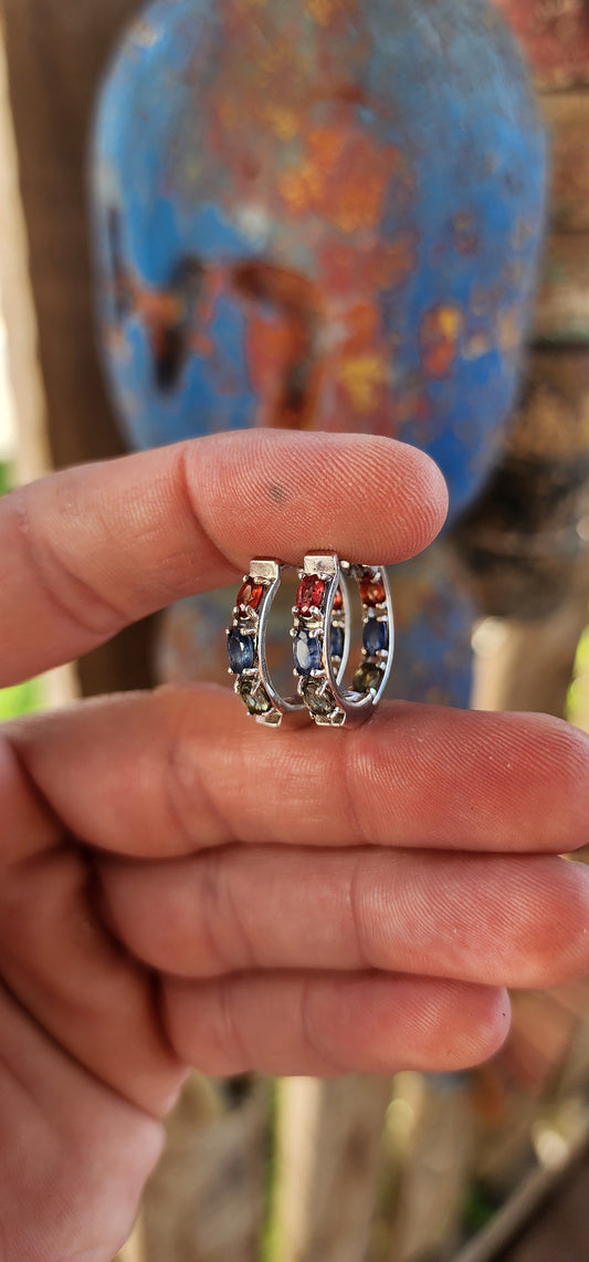 These sterling silver and multicolor sapphire huggie hoop earrings are absolutely breathtaking!
These elegant huggies are crafted in sterling silver, forming a seamless circular design that gently hugs the earlobe.