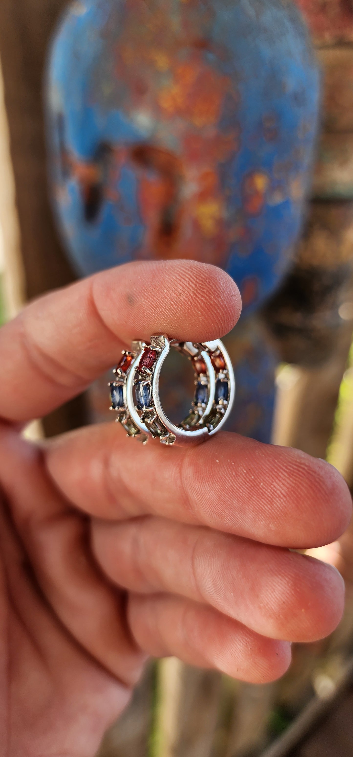 These sterling silver and multicolor sapphire huggie hoop earrings are absolutely breathtaking!
These elegant huggies are crafted in sterling silver, forming a seamless circular design that gently hugs the earlobe.