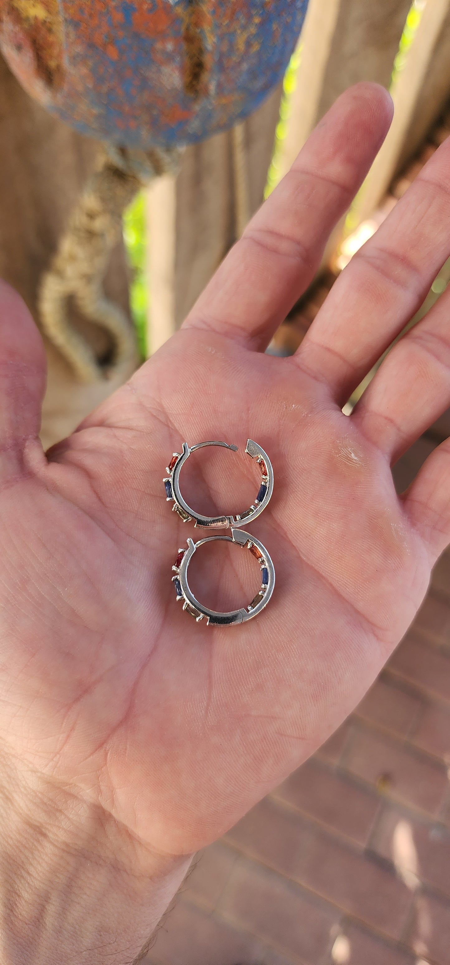 These sterling silver and multicolor sapphire huggie hoop earrings are absolutely breathtaking!
These elegant huggies are crafted in sterling silver, forming a seamless circular design that gently hugs the earlobe.