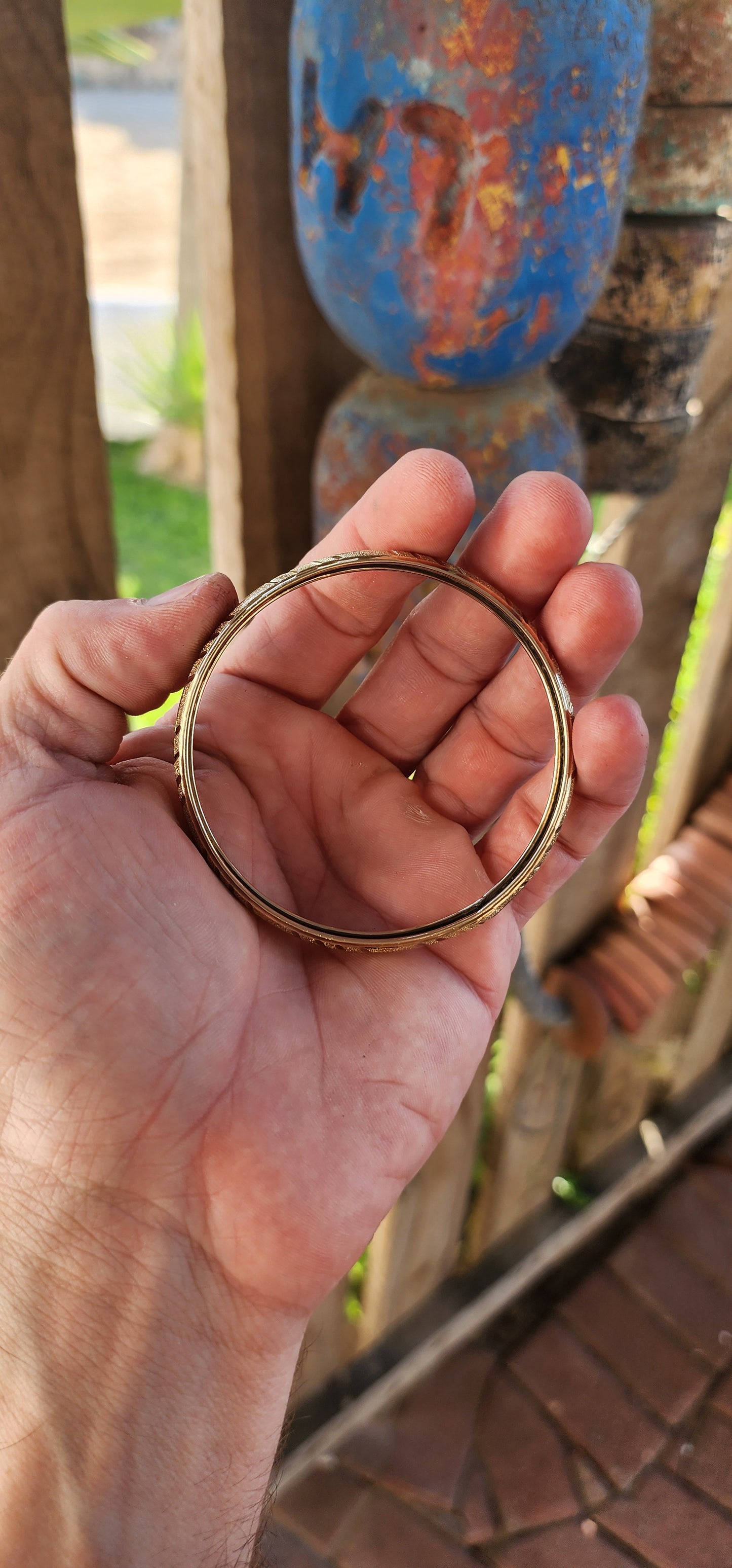 This vintage 9ct yellow gold bangle is a stunning example of classic elegance fused with exquisite craftsmanship. Designed in a domed C-shape, this bangle contours gracefully around the wrist, offering both a comfortable fit and a bold presence.