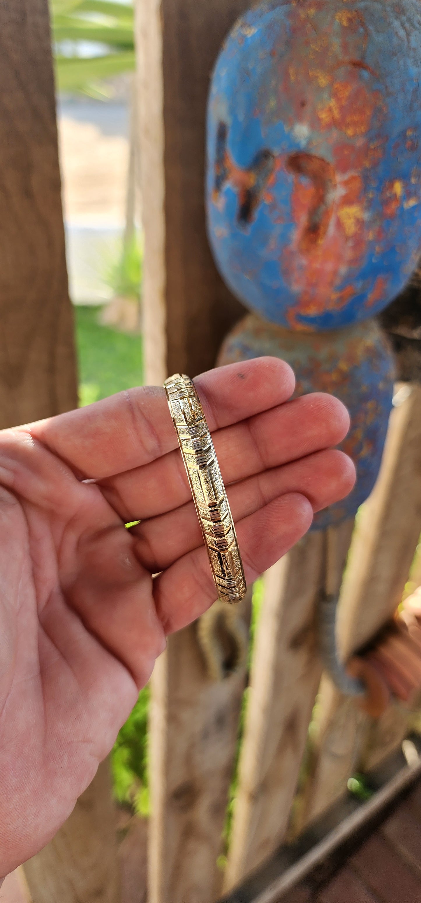 This vintage 9ct yellow gold bangle is a stunning example of classic elegance fused with exquisite craftsmanship. Designed in a domed C-shape, this bangle contours gracefully around the wrist, offering both a comfortable fit and a bold presence.