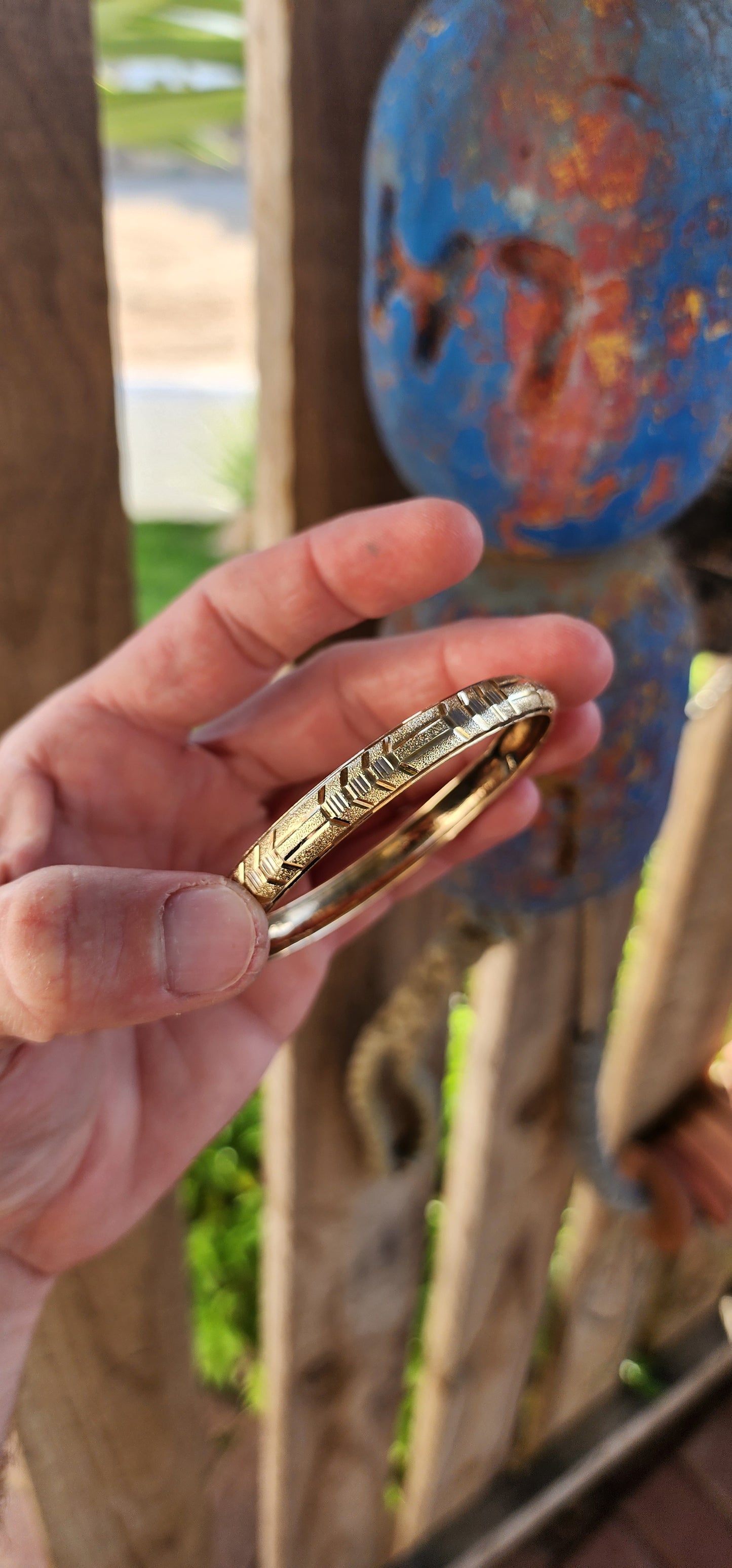 This vintage 9ct yellow gold bangle is a stunning example of classic elegance fused with exquisite craftsmanship. Designed in a domed C-shape, this bangle contours gracefully around the wrist, offering both a comfortable fit and a bold presence.