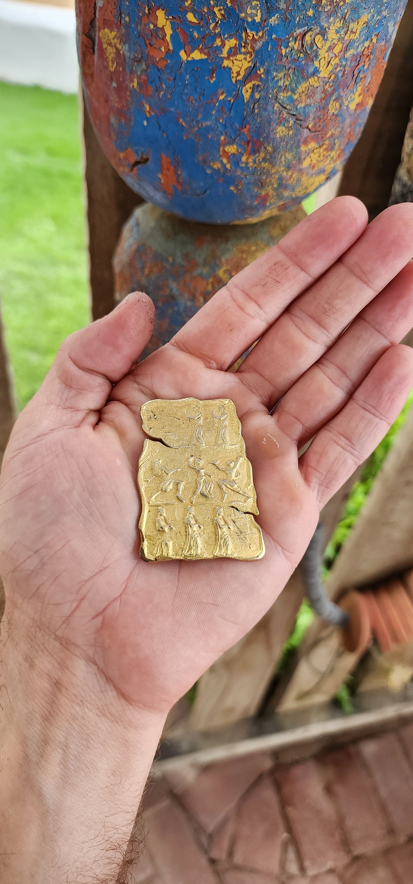 This is a striking vintage gold-tone costume brooch with a bold, ancient-inspired aesthetic. The brooch has an irregular, tablet-like shape, reminiscent of an archaeological artifact or an ancient carved relief.