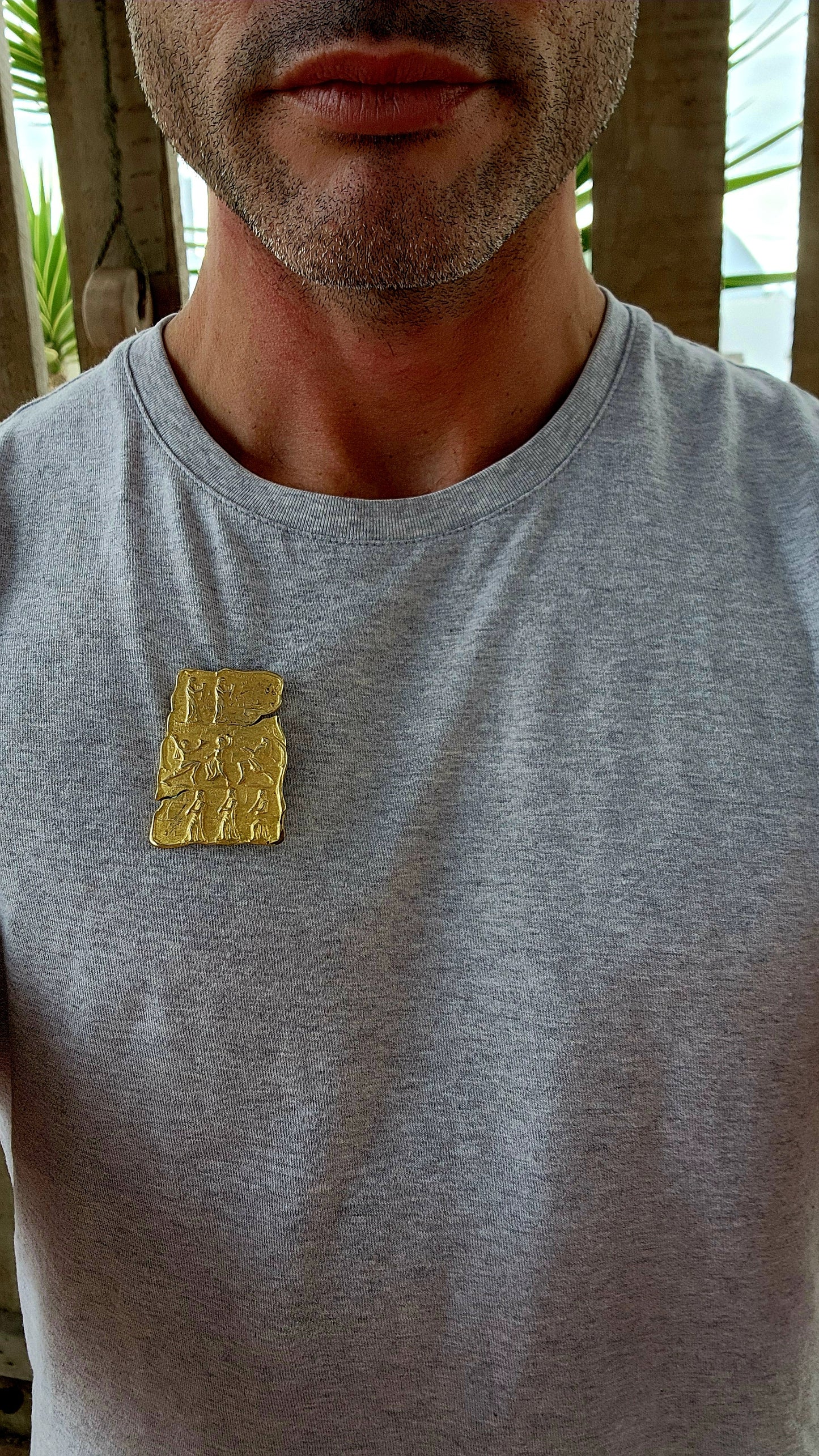 This is a striking vintage gold-tone costume brooch with a bold, ancient-inspired aesthetic. The brooch has an irregular, tablet-like shape, reminiscent of an archaeological artifact or an ancient carved relief.