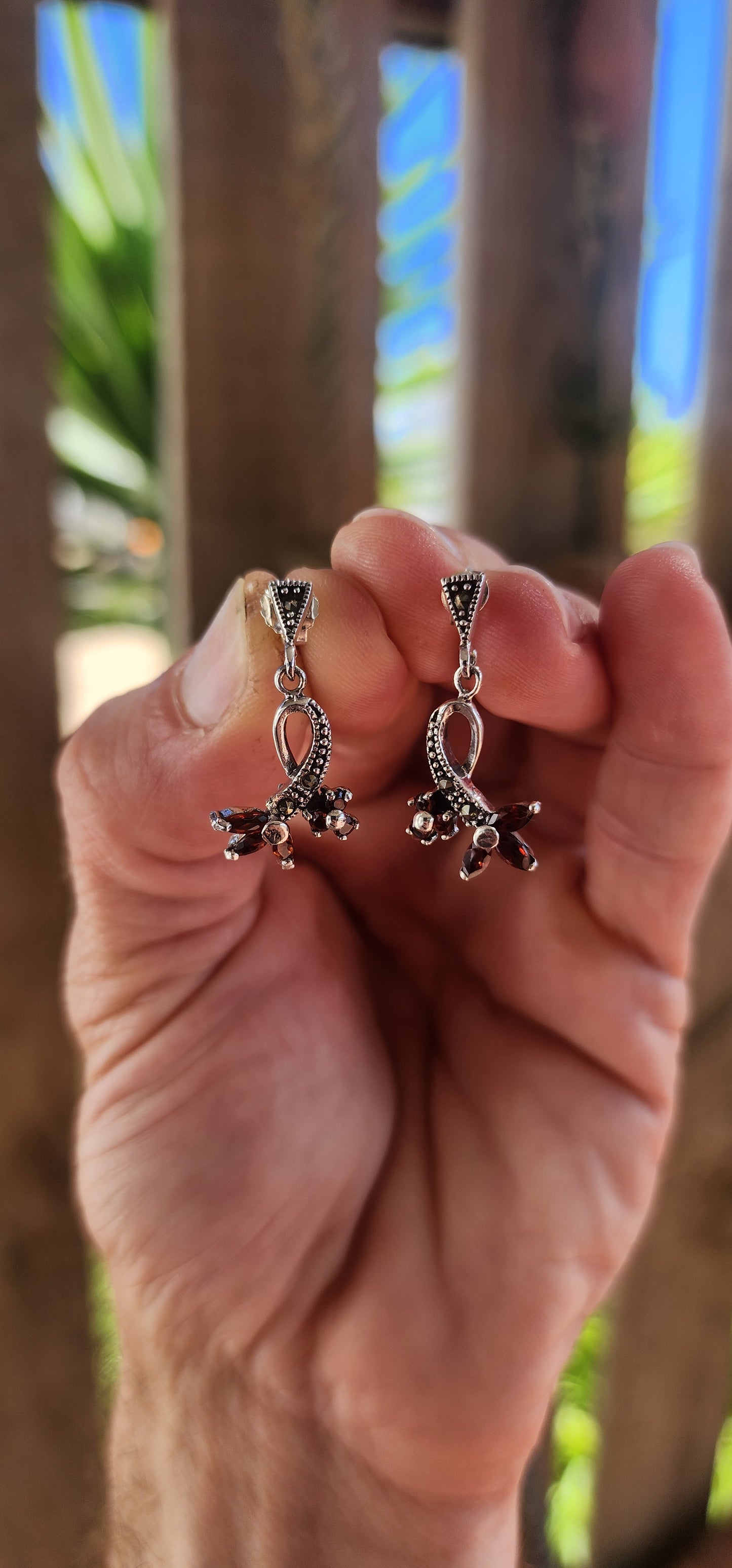 A captivating dance of vintage style elegance and gemstone drama, these sterling silver drop earrings are like wearable works of art with a whisper of Victorian flair and a touch of botanical fantasy.