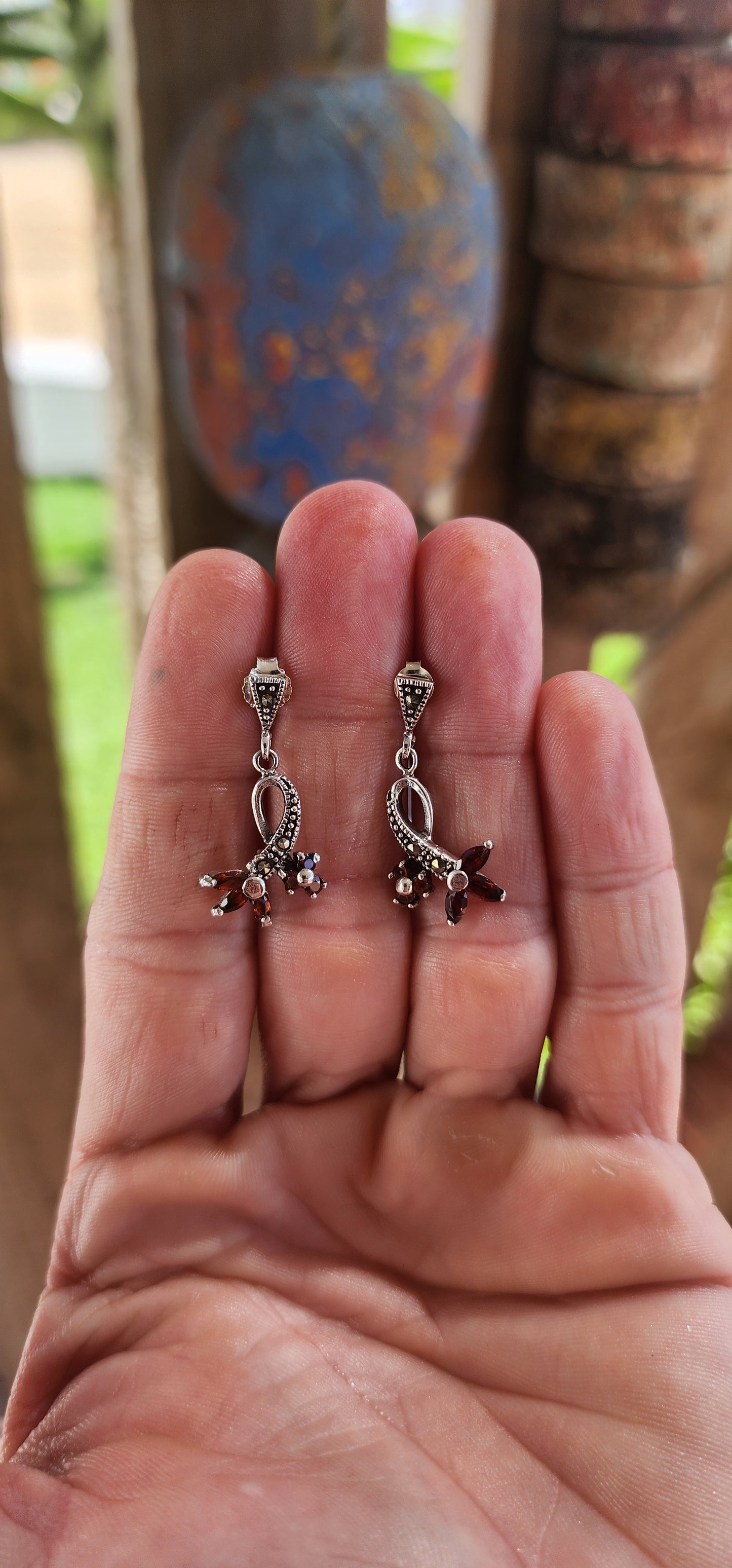 A captivating dance of vintage style elegance and gemstone drama, these sterling silver drop earrings are like wearable works of art with a whisper of Victorian flair and a touch of botanical fantasy.