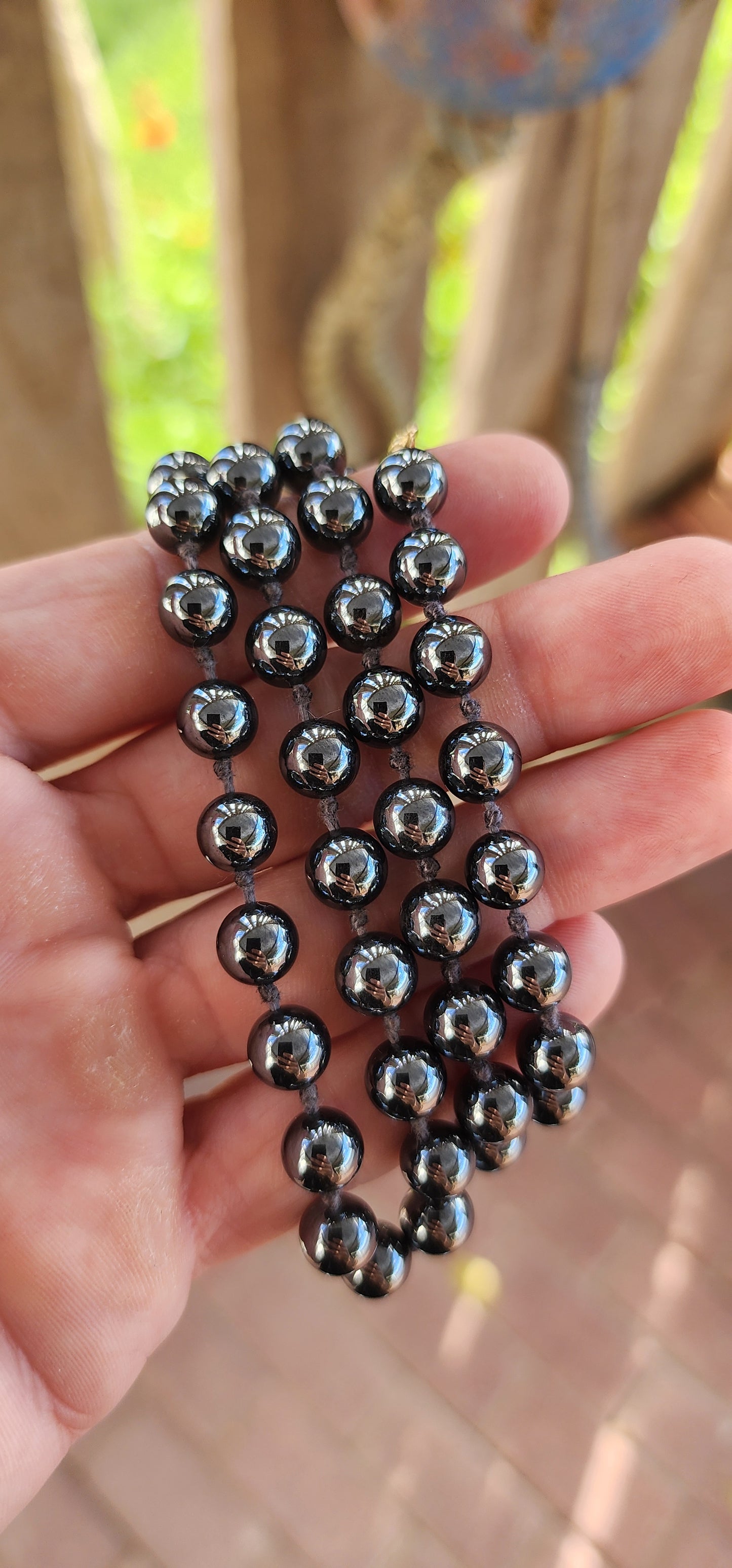 This necklace is giving vintage mystery with a touch of rockstar cool. Extra long, sultry strand of glossy hematite gemstone beads—perfectly round, highly polished, and dark as a midnight mirror.