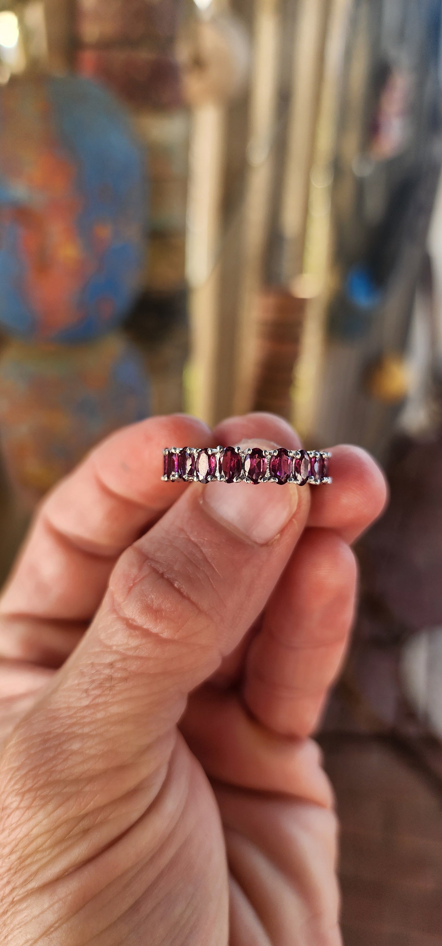 This sterling silver full eternity ring is a dazzling display of deep, rich purple rhodolite garnets, meticulously claw-set in an endless circle of brilliance.
