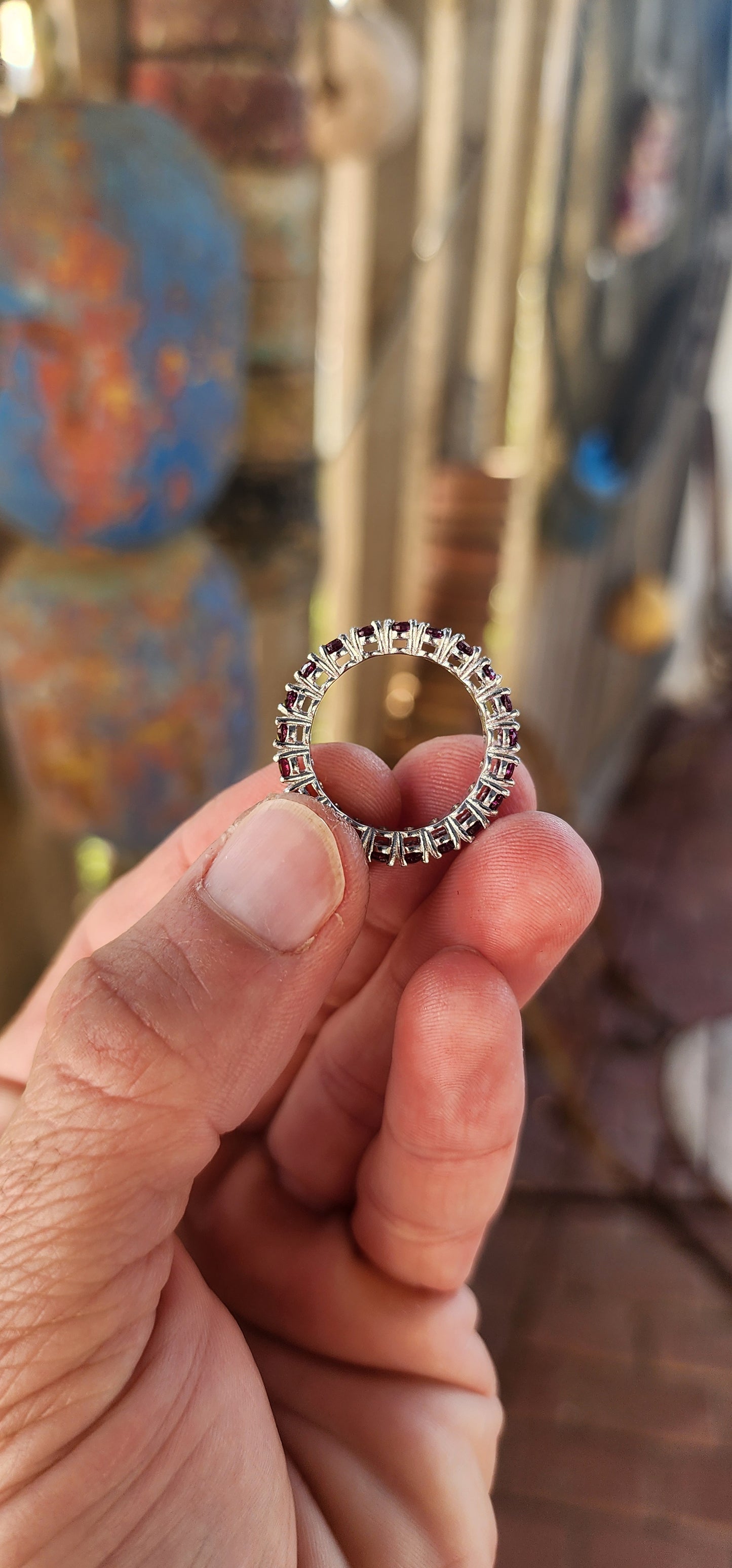 This sterling silver full eternity ring is a dazzling display of deep, rich purple rhodolite garnets, meticulously claw-set in an endless circle of brilliance.