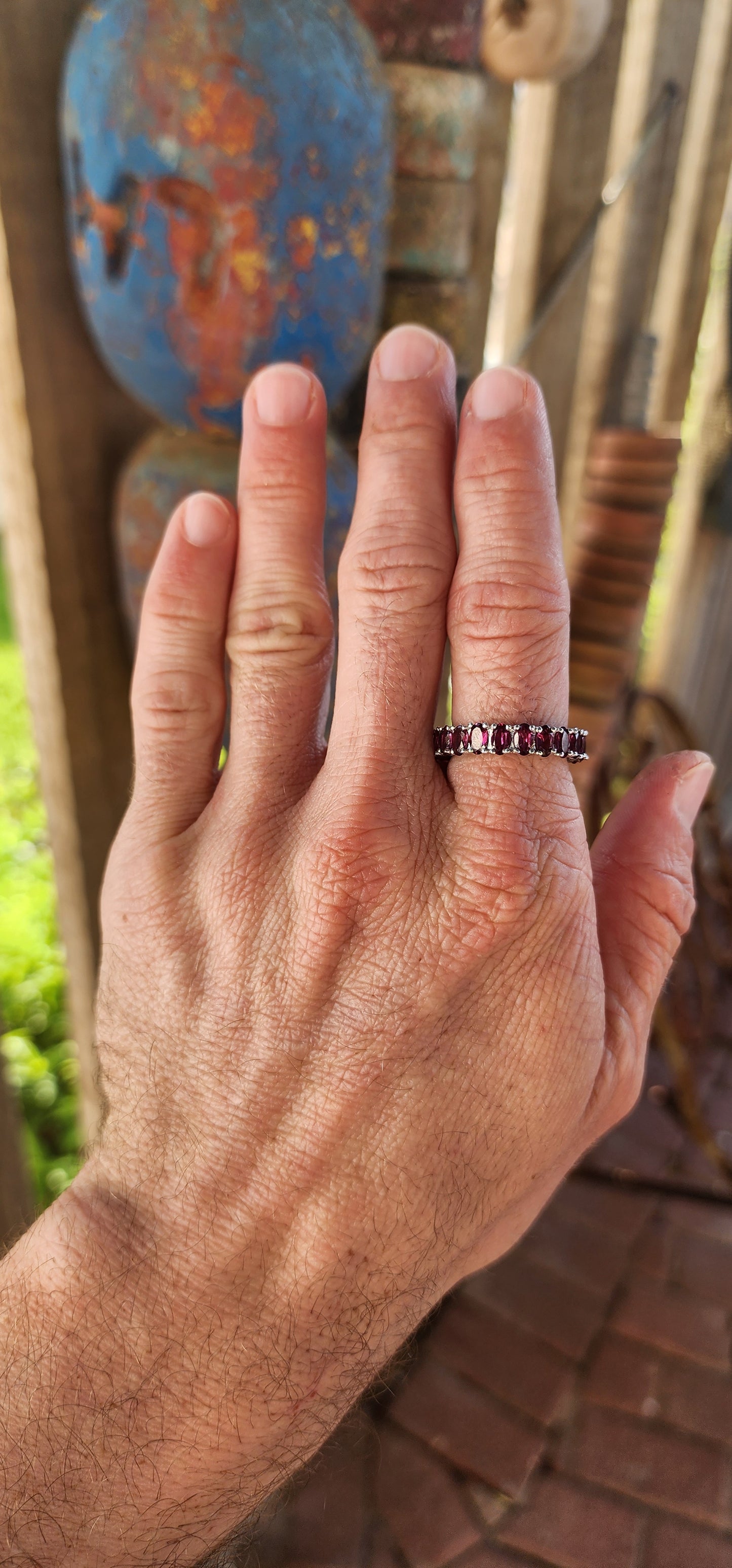 This sterling silver full eternity ring is a dazzling display of deep, rich purple rhodolite garnets, meticulously claw-set in an endless circle of brilliance.