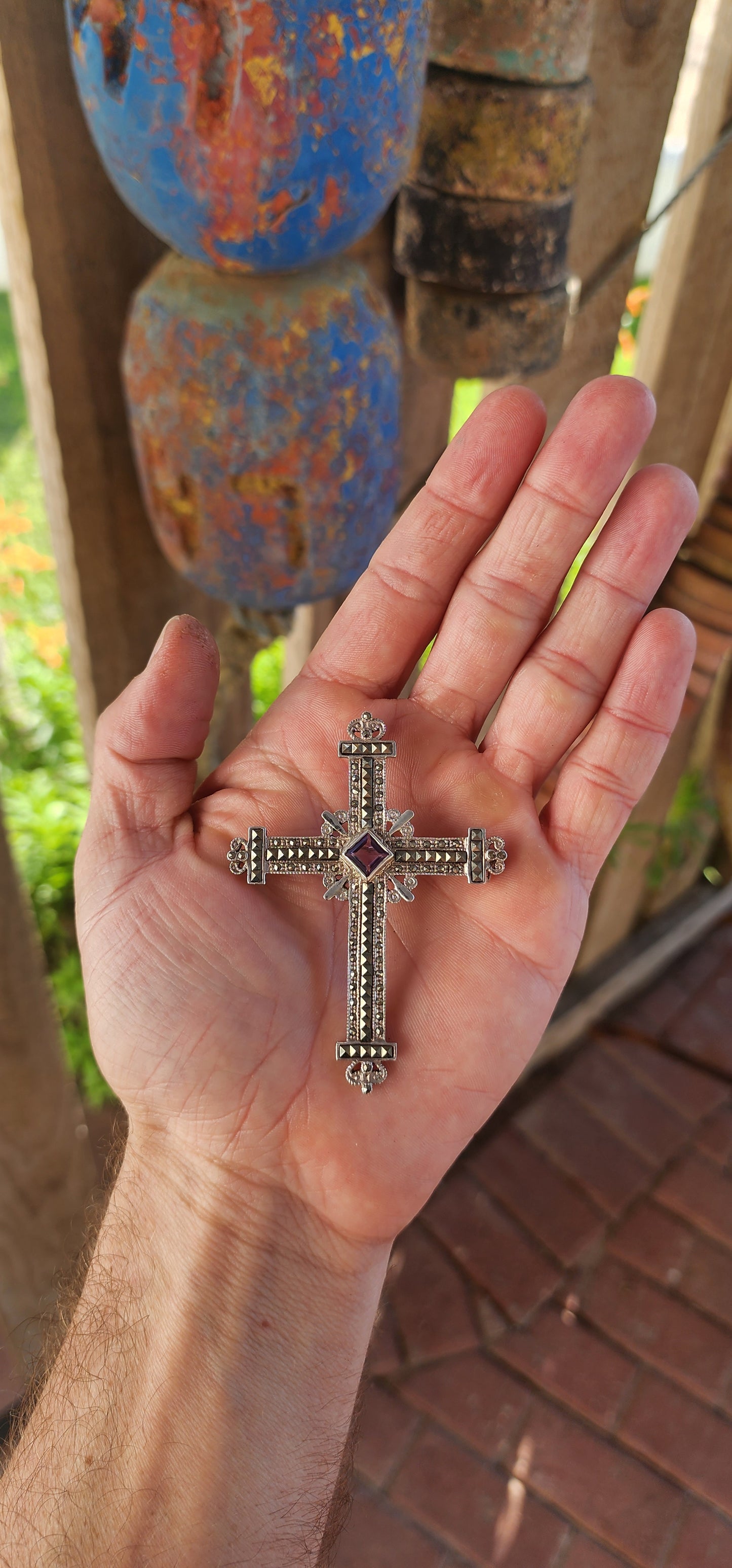 Fit for the breastplate of a crusader prince or the cloak of a baroque queen, this magnificent sterling silver cross brooch-pendant is nothing short of spectacular.