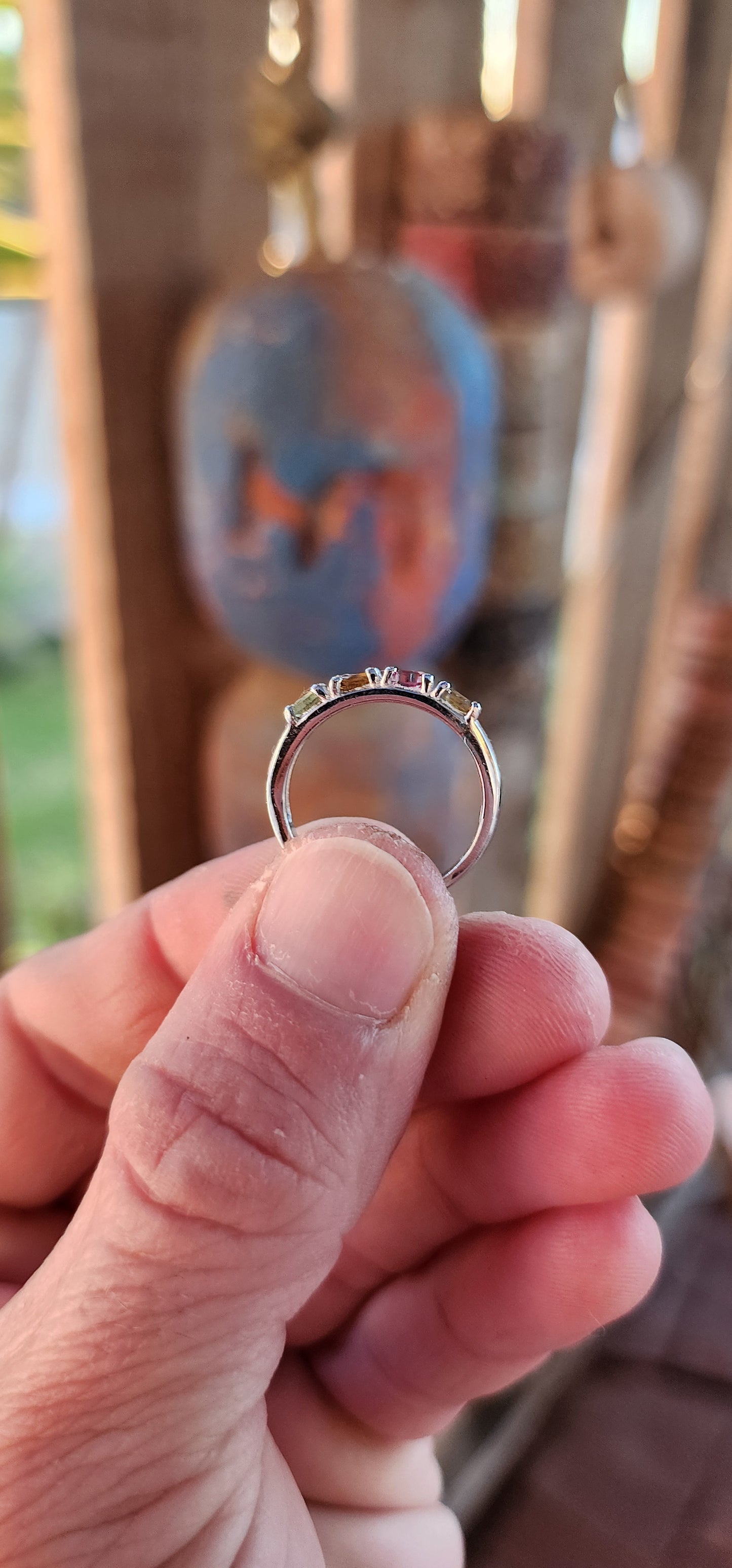 Let your fingers tell a story of color and wonder with this enchanting sterling silver half-eternity ring. Prong-set along the polished silver band are four oval-cut multi-colored tourmalines, each a glowing whisper of nature’s palette.