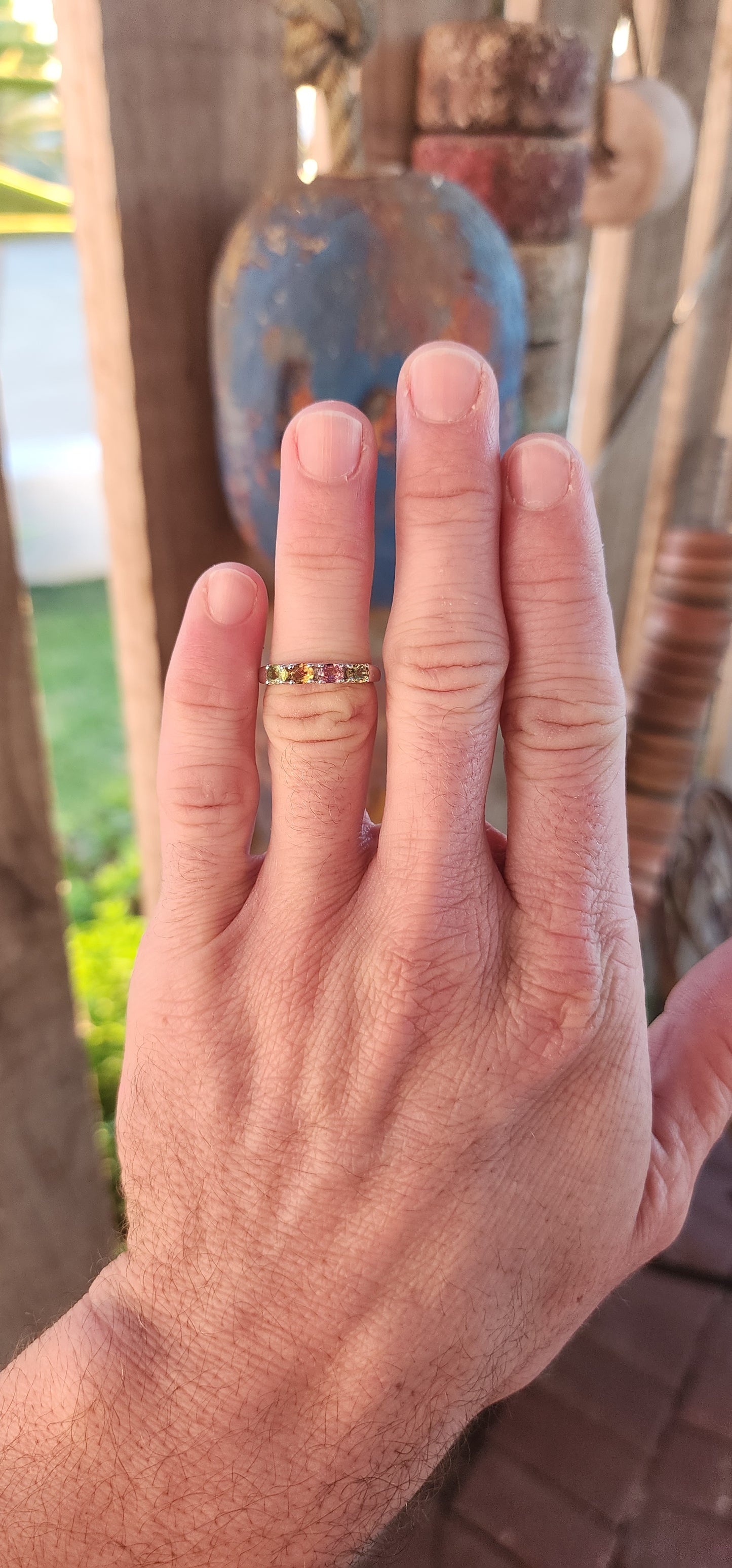 Let your fingers tell a story of color and wonder with this enchanting sterling silver half-eternity ring. Prong-set along the polished silver band are four oval-cut multi-colored tourmalines, each a glowing whisper of nature’s palette.