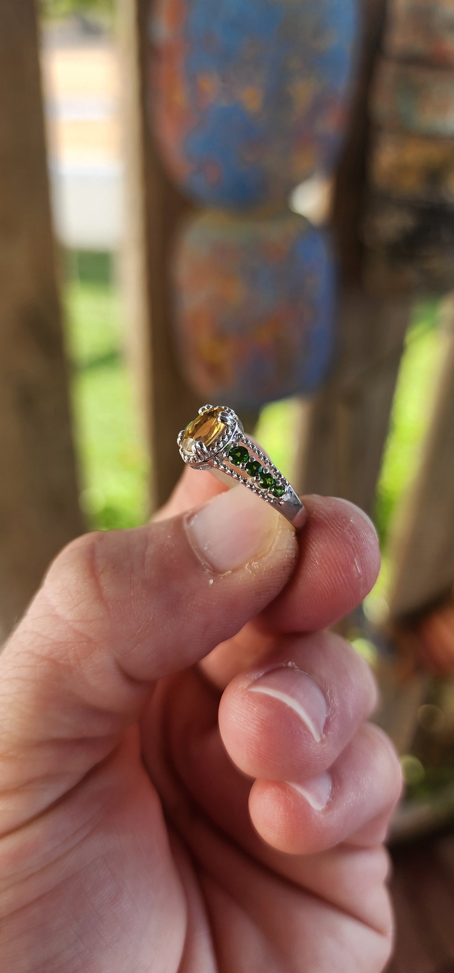 This dazzling beauty is a half-eternity ring with a twist—a bold and funky fusion of citrus-bright and woodland-deep tones that makes her anything but ordinary.