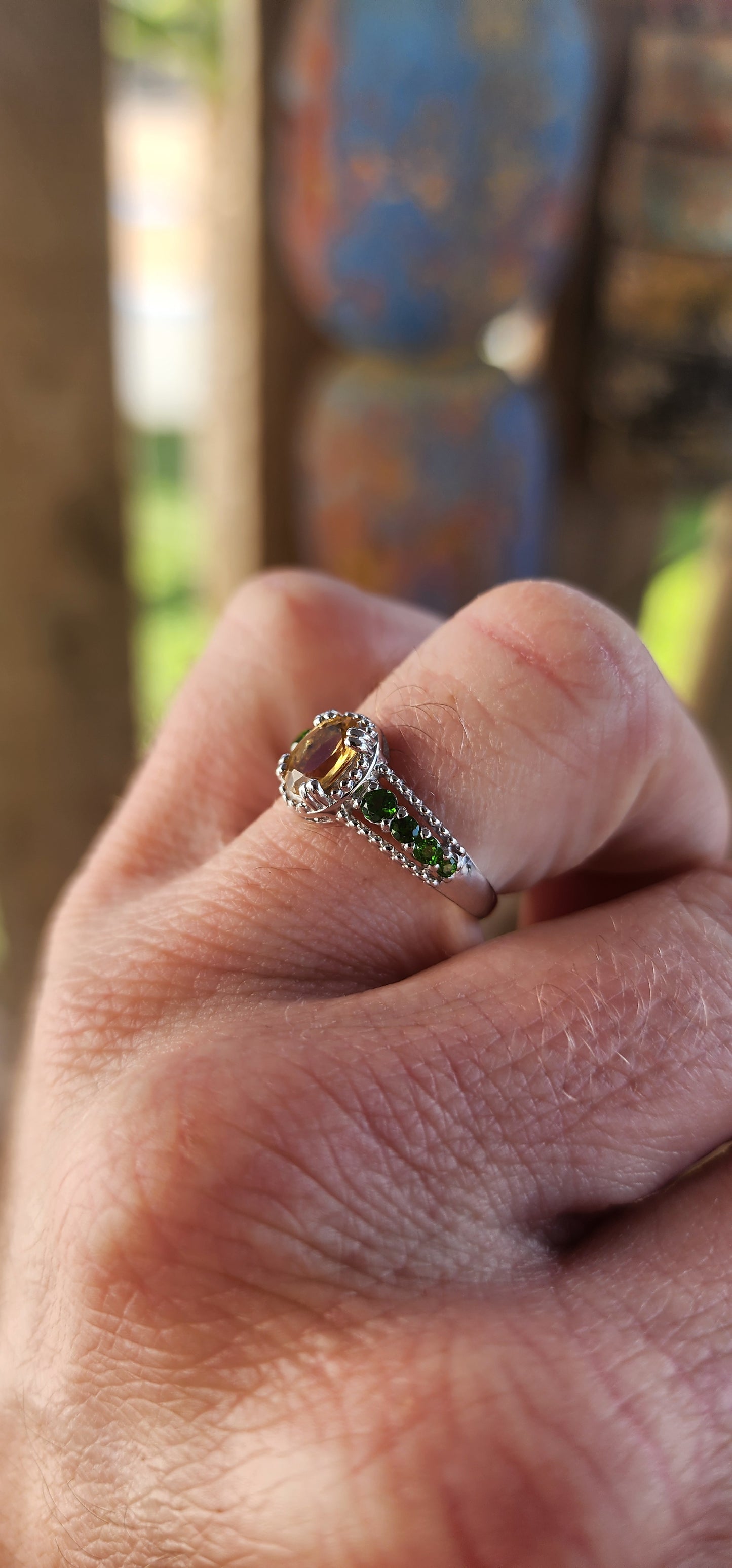 This dazzling beauty is a half-eternity ring with a twist—a bold and funky fusion of citrus-bright and woodland-deep tones that makes her anything but ordinary.