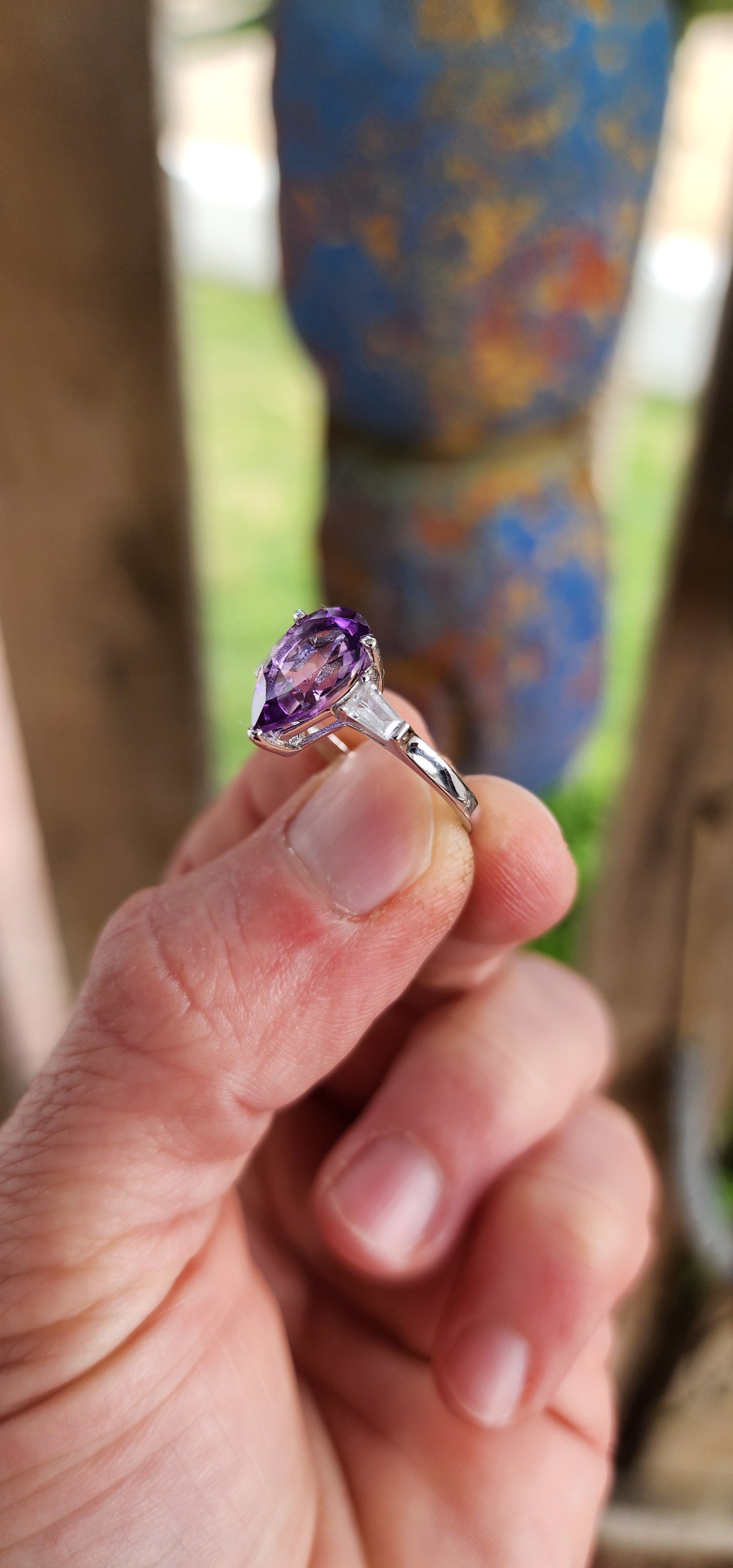 Prepare to be enchanted — this sterling silver trilogy ring is pure majesty wrapped in violet fire and classic elegance!