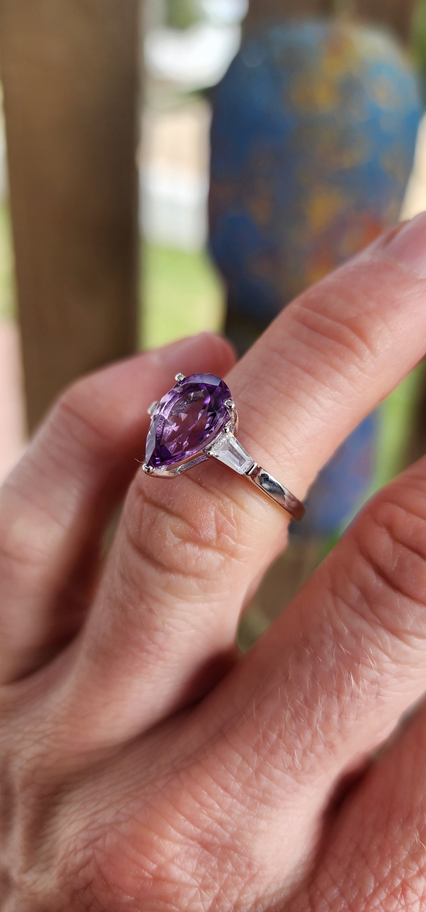 Prepare to be enchanted — this sterling silver trilogy ring is pure majesty wrapped in violet fire and classic elegance!