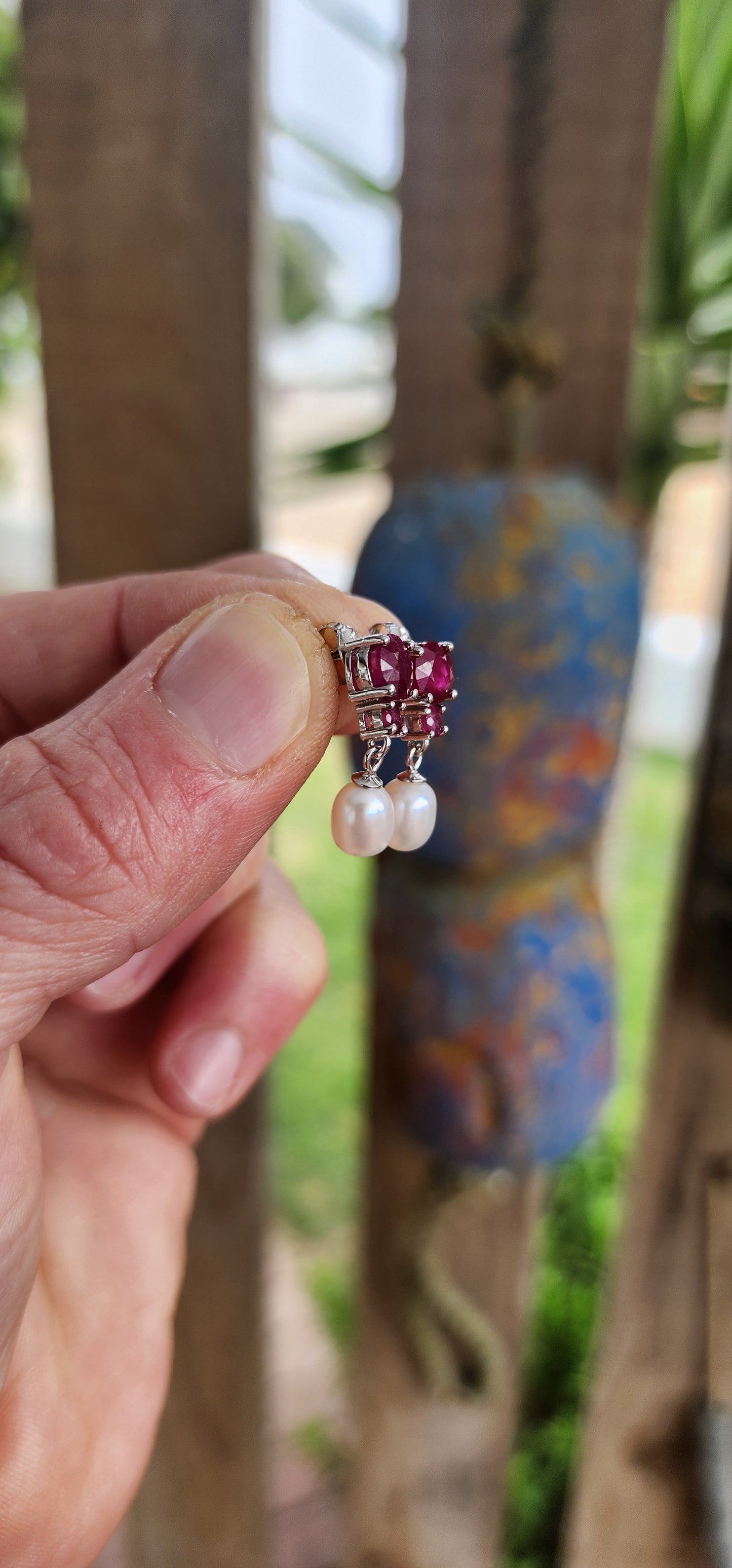These radiant sterling silver earrings are a celebration of timeless romance .At their crown, each earring features a round-cut ruby in a rich, velvety crimson hue—expertly prong-set to capture and dance with the light like a spark from a royal hearth.