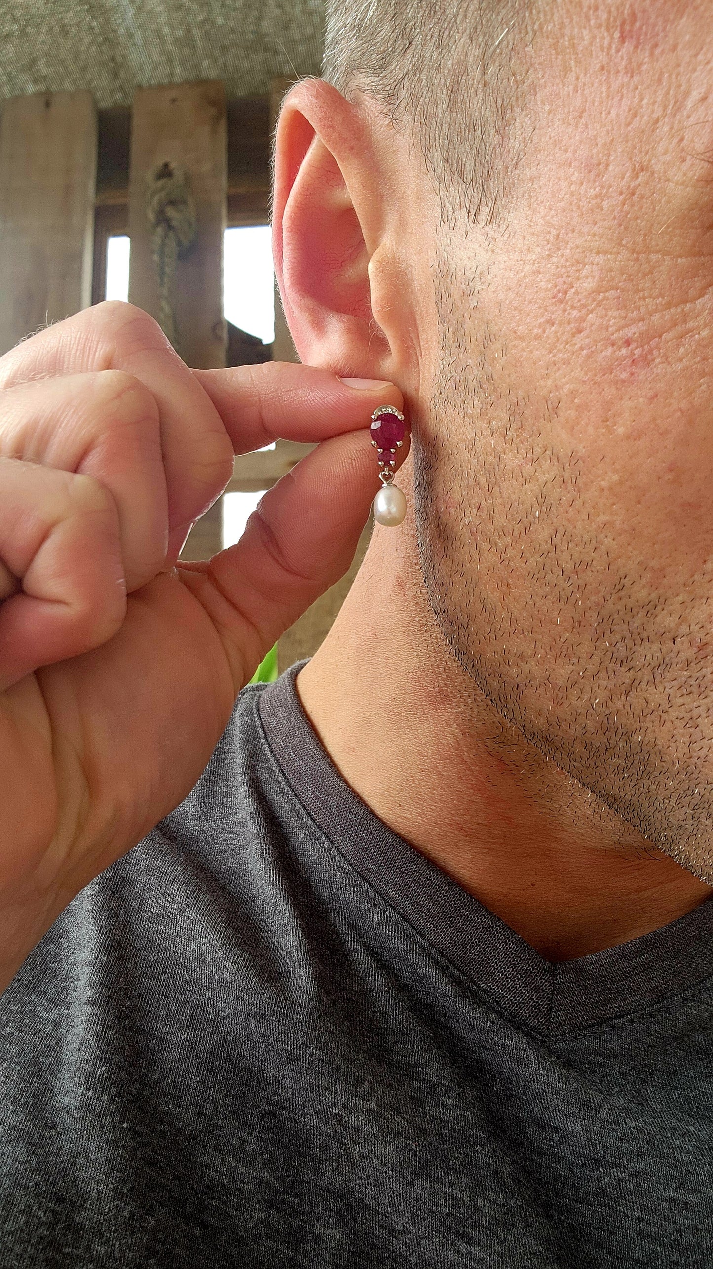These radiant sterling silver earrings are a celebration of timeless romance .At their crown, each earring features a round-cut ruby in a rich, velvety crimson hue—expertly prong-set to capture and dance with the light like a spark from a royal hearth.