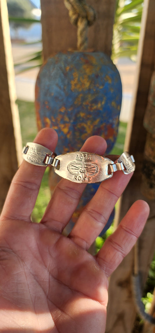 Jet-set glamour meets nostalgic charm in this vintage panel bracelet by iconic French jewelry house Gas Bijoux. This beauty is silver-plated and handcrafted in the distinctive style of WWII-era Italian souvenir bracelets.