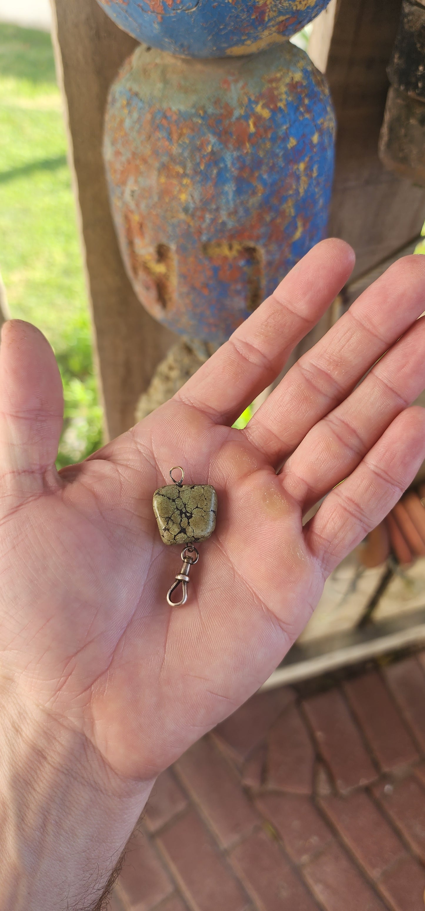 This antique fob pendant is a pocket-sized keepsake of Victorian ingenuity and charm, brought to life with a soul-stirring gem from the heart of the earth.
