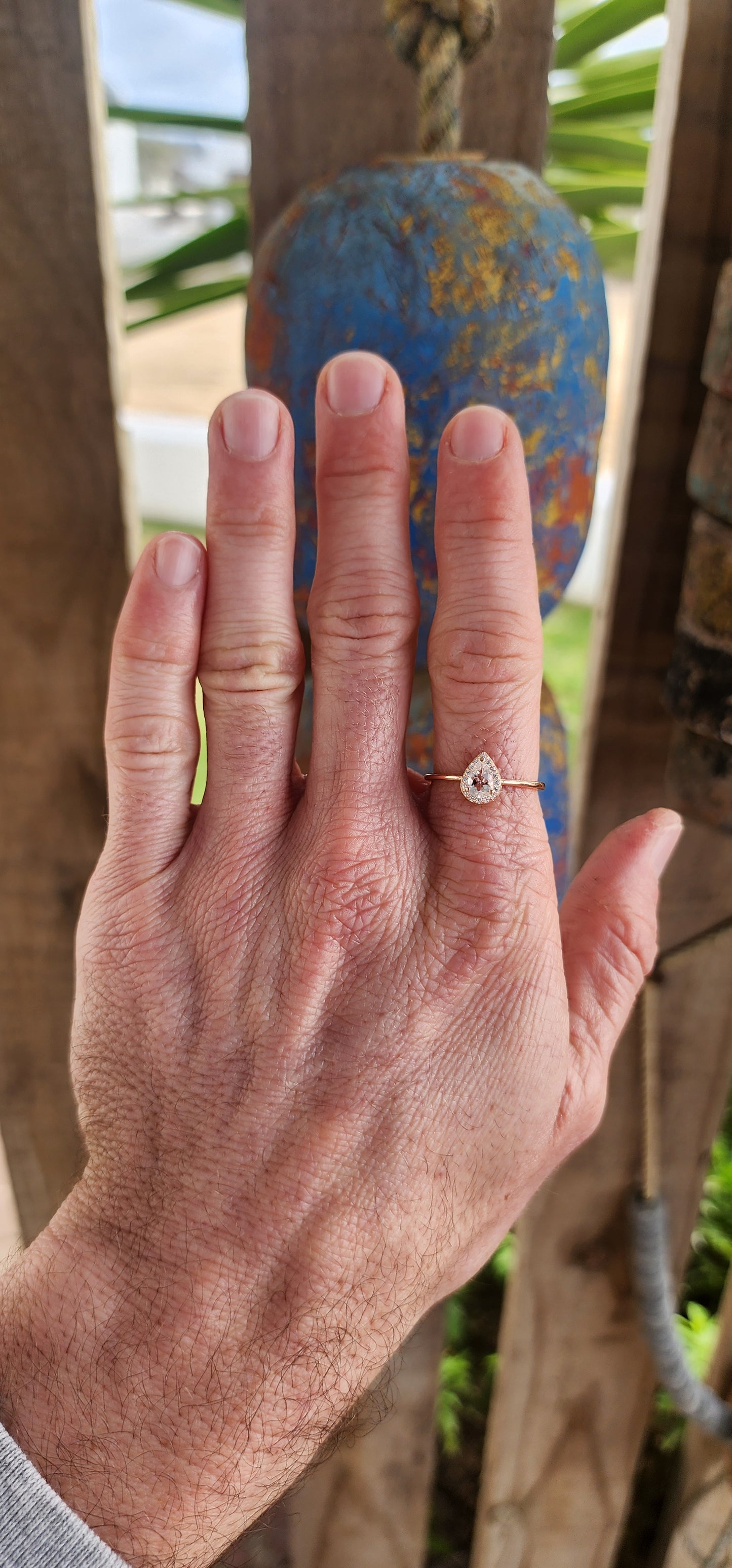 As delicate as the morning's first kiss of sunlight, this enchanting ring is a love letter in rose gold over sterling silver . Nestled at its heart is a pear-cut morganite gemstone, glowing softly like a drop of blushing dew caught at dawn.