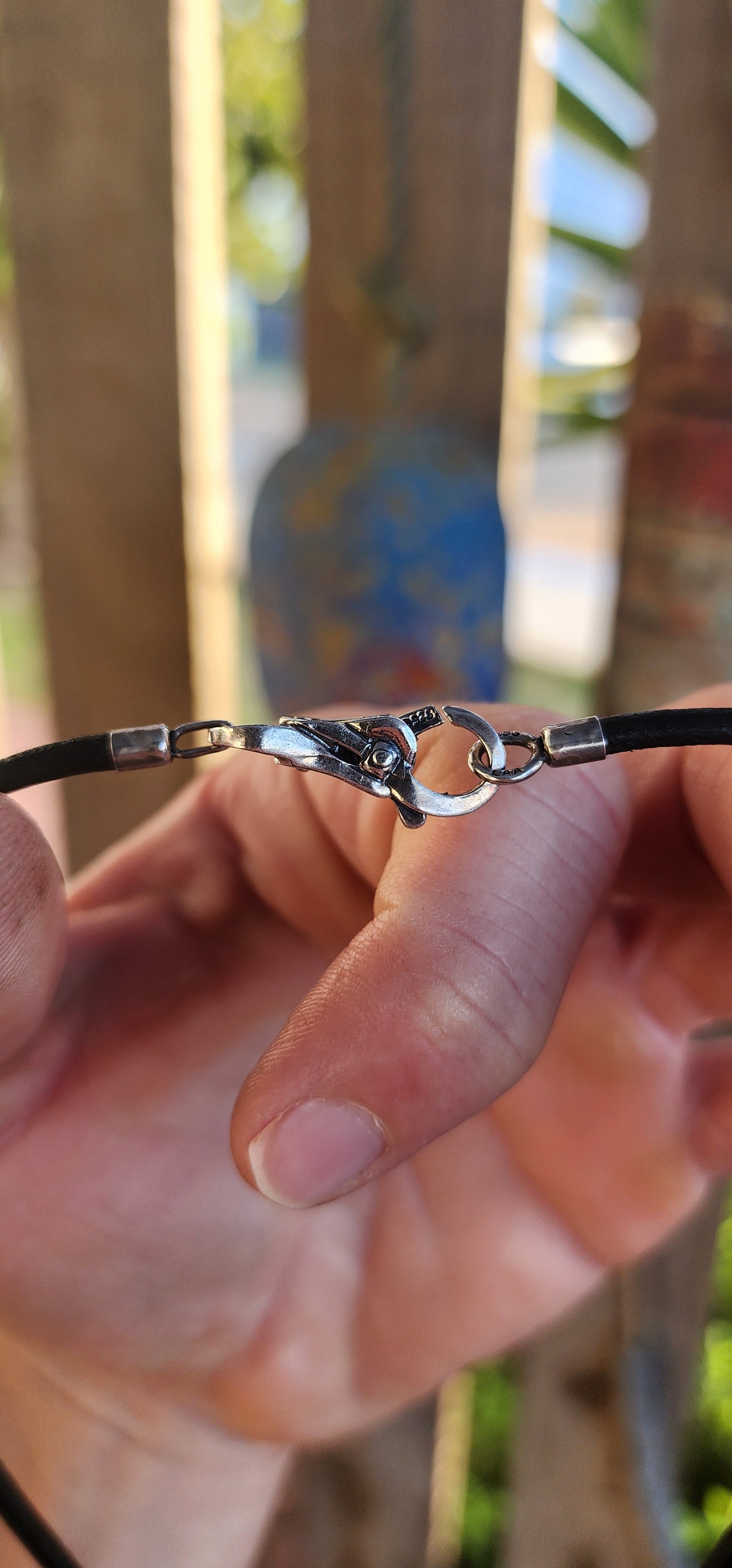Channeling both modern cool and mystical charm, this unisex designer necklace by T-r-o-l-l-b-e-a-d-s is a wearable piece of art.