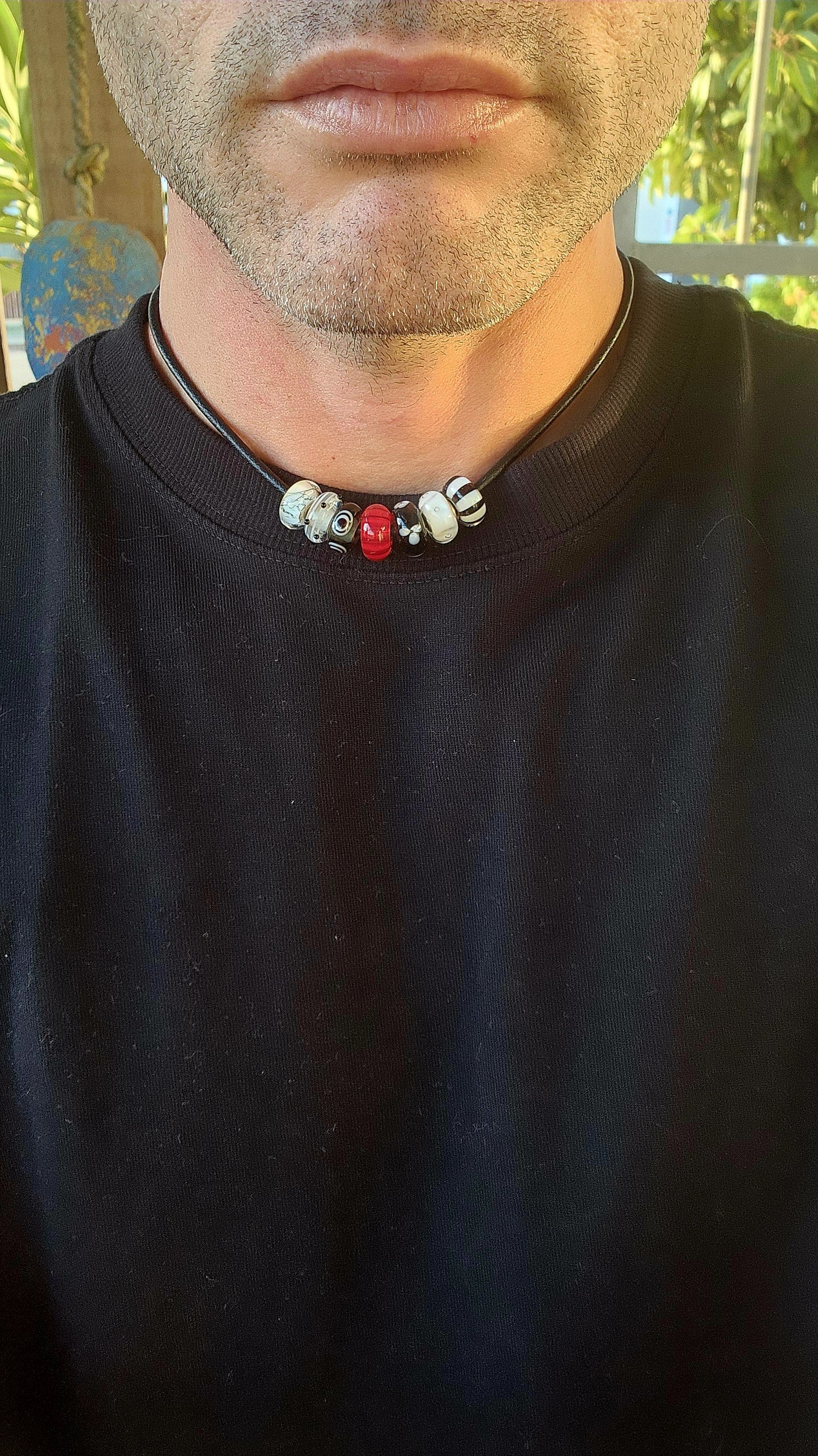 Channeling both modern cool and mystical charm, this unisex designer necklace by T-r-o-l-l-b-e-a-d-s is a wearable piece of art.