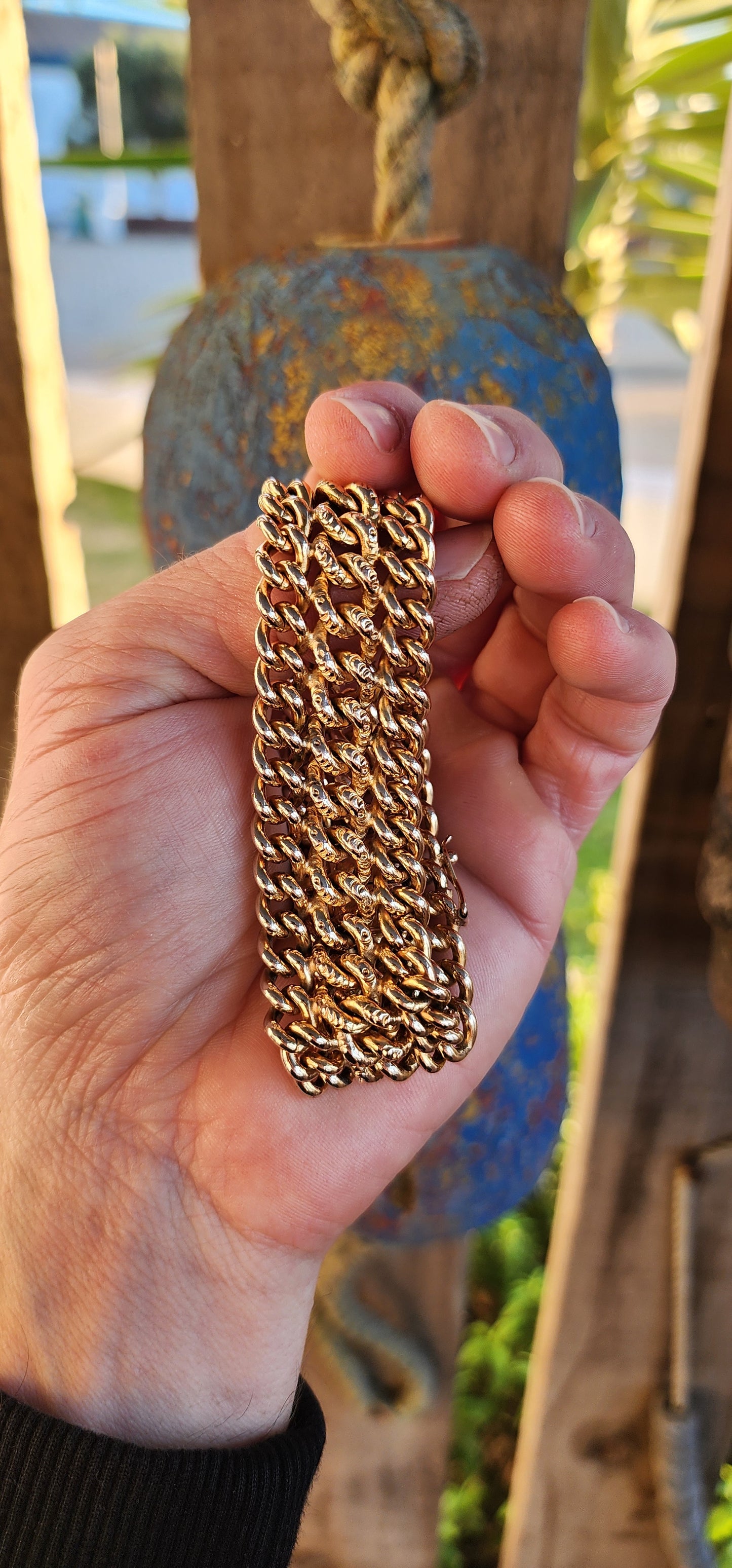 A rare survivor of mid-century mastery, this vintage rosy-yellow gold plated bracelet transforms simple curb links into a richly textured tapestry of bold elegance.