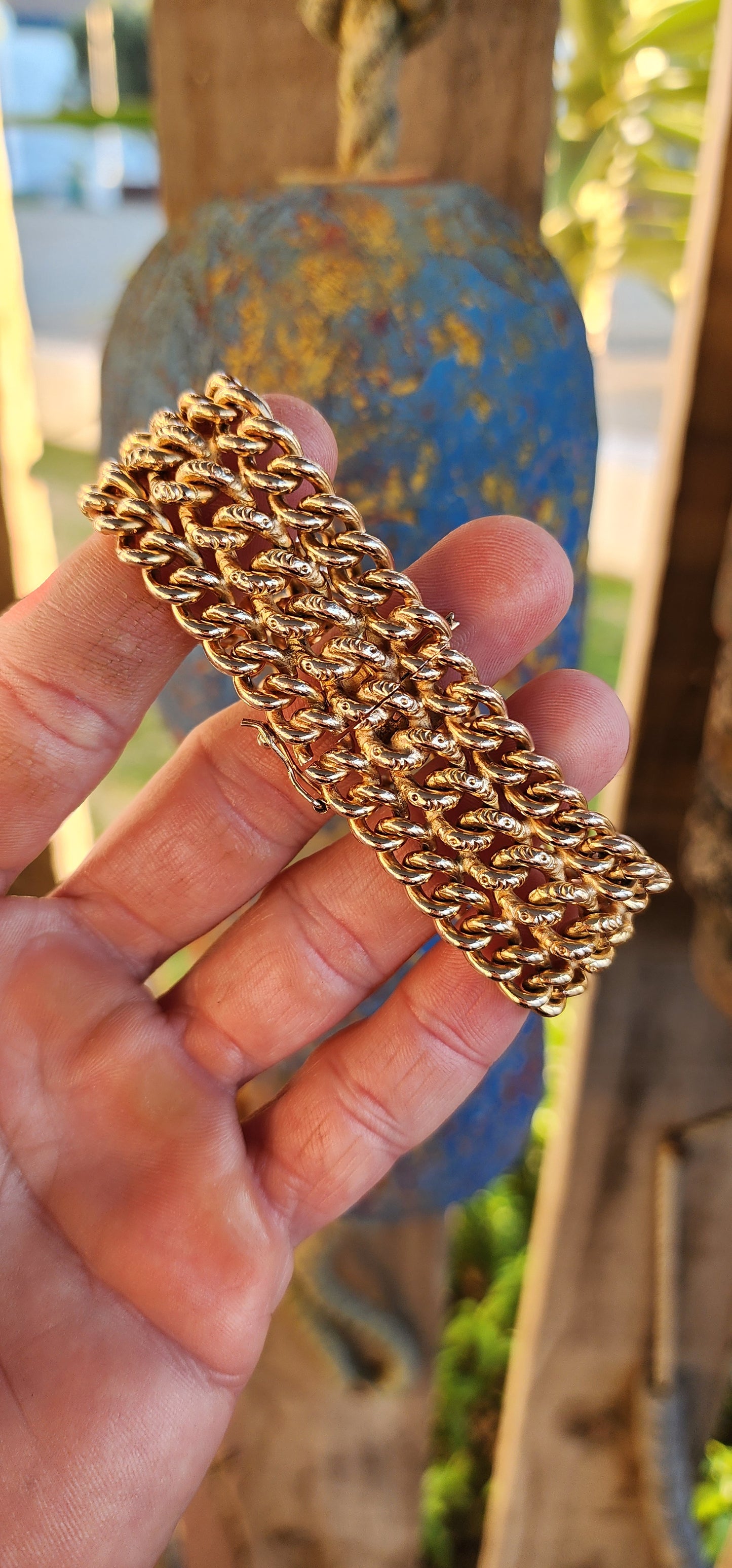 A rare survivor of mid-century mastery, this vintage rosy-yellow gold plated bracelet transforms simple curb links into a richly textured tapestry of bold elegance.