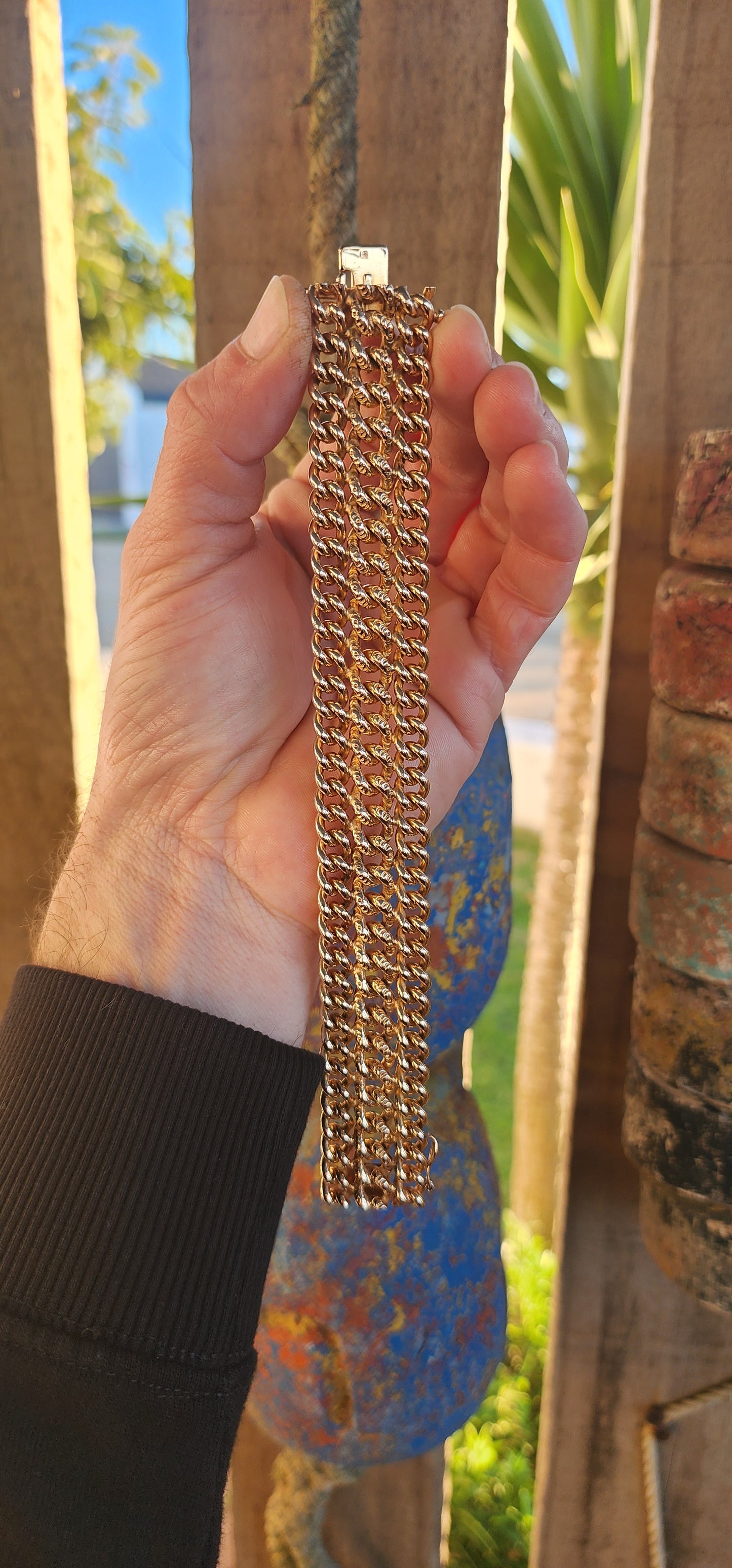 A rare survivor of mid-century mastery, this vintage rosy-yellow gold plated bracelet transforms simple curb links into a richly textured tapestry of bold elegance.
