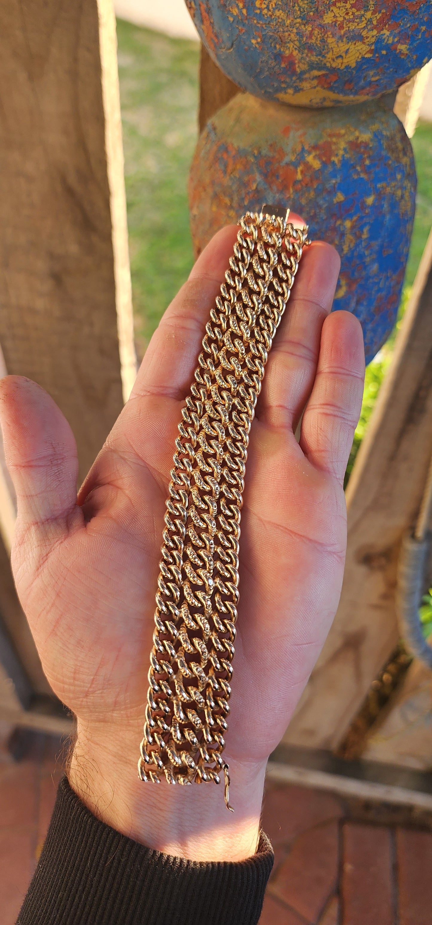 A rare survivor of mid-century mastery, this vintage rosy-yellow gold plated bracelet transforms simple curb links into a richly textured tapestry of bold elegance.