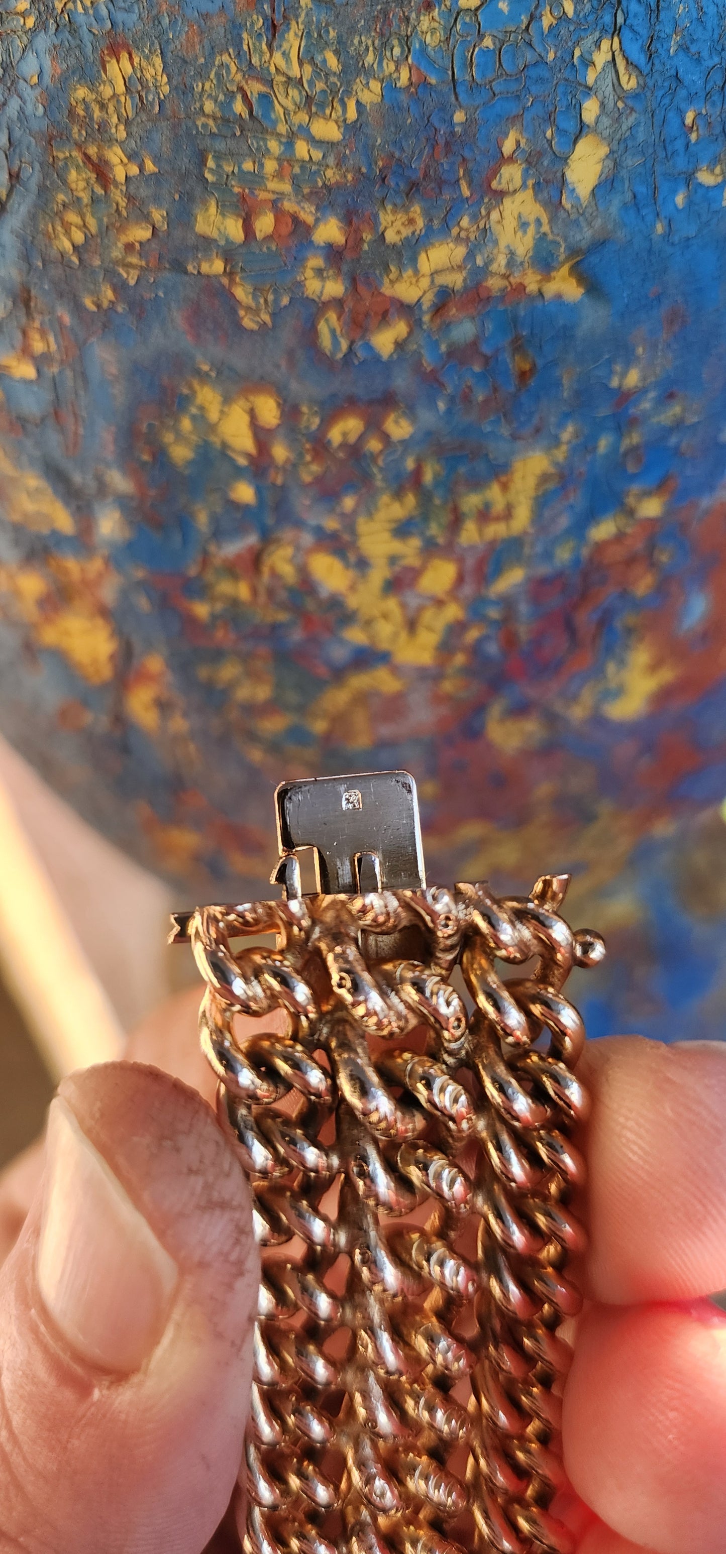 A rare survivor of mid-century mastery, this vintage rosy-yellow gold plated bracelet transforms simple curb links into a richly textured tapestry of bold elegance.