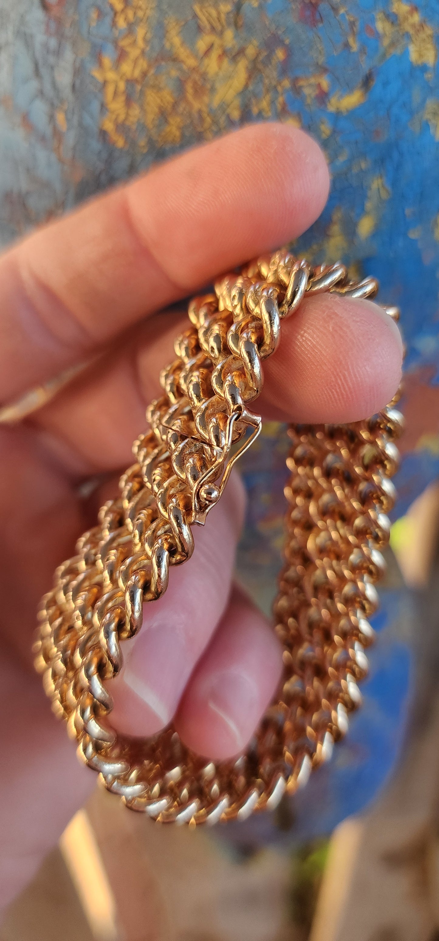 A rare survivor of mid-century mastery, this vintage rosy-yellow gold plated bracelet transforms simple curb links into a richly textured tapestry of bold elegance.