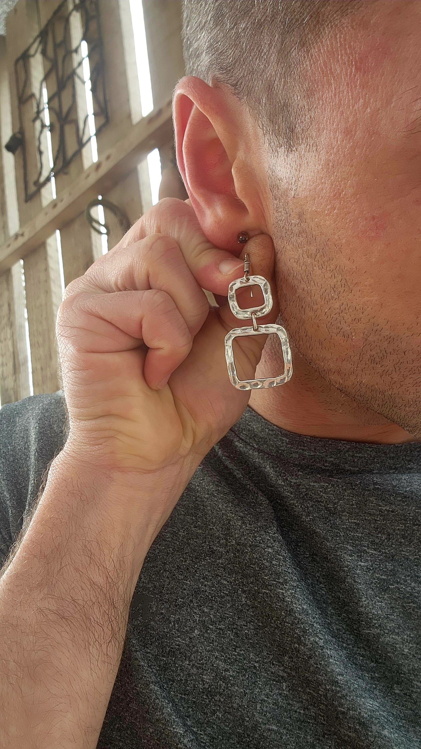These artisan-made modernist drop earrings are crafted in sterling silver with a bold, sculptural flair.
