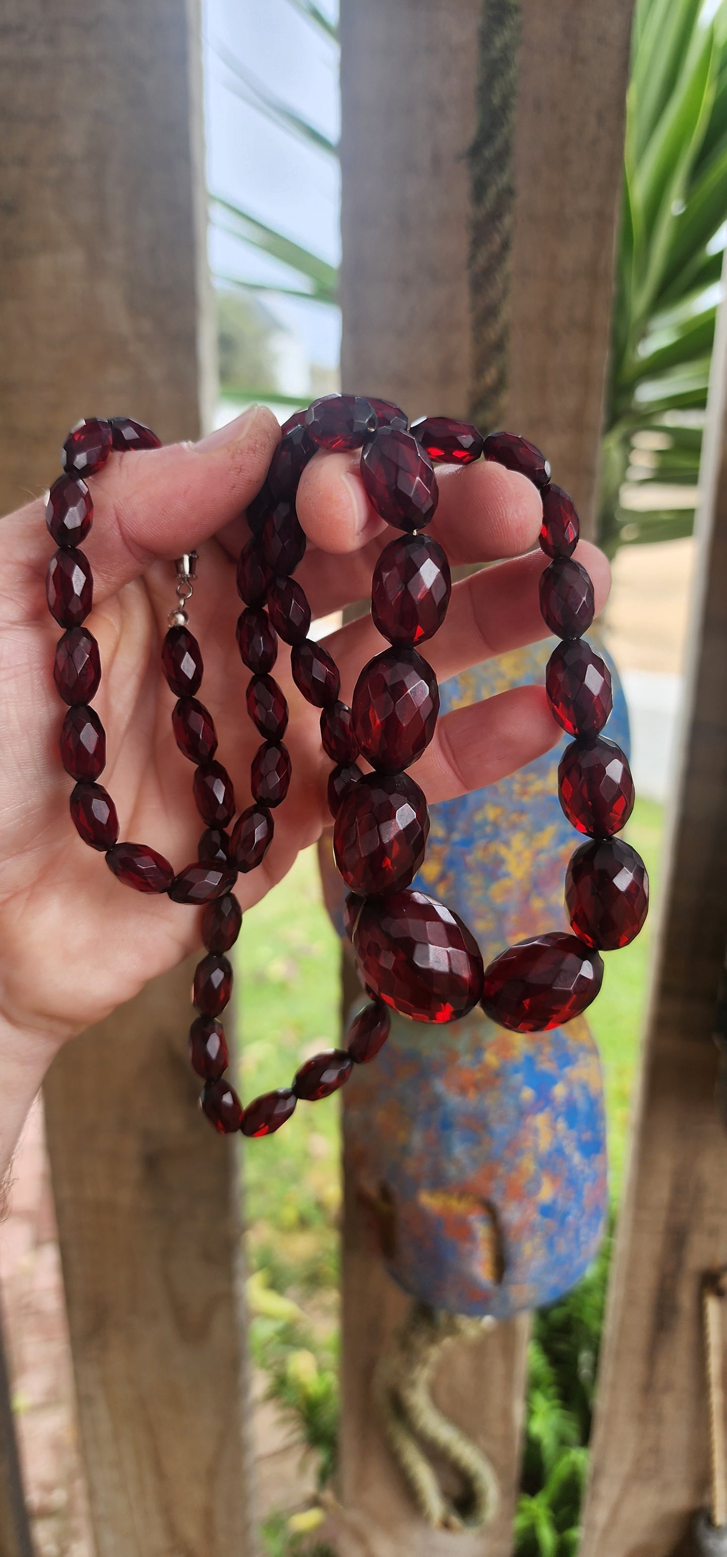 This exquisite vintage necklace is a radiant example of 1930s Art Deco glamour, showcasing hand-faceted cherry Bakelite beads in a beautifully graduated design.
