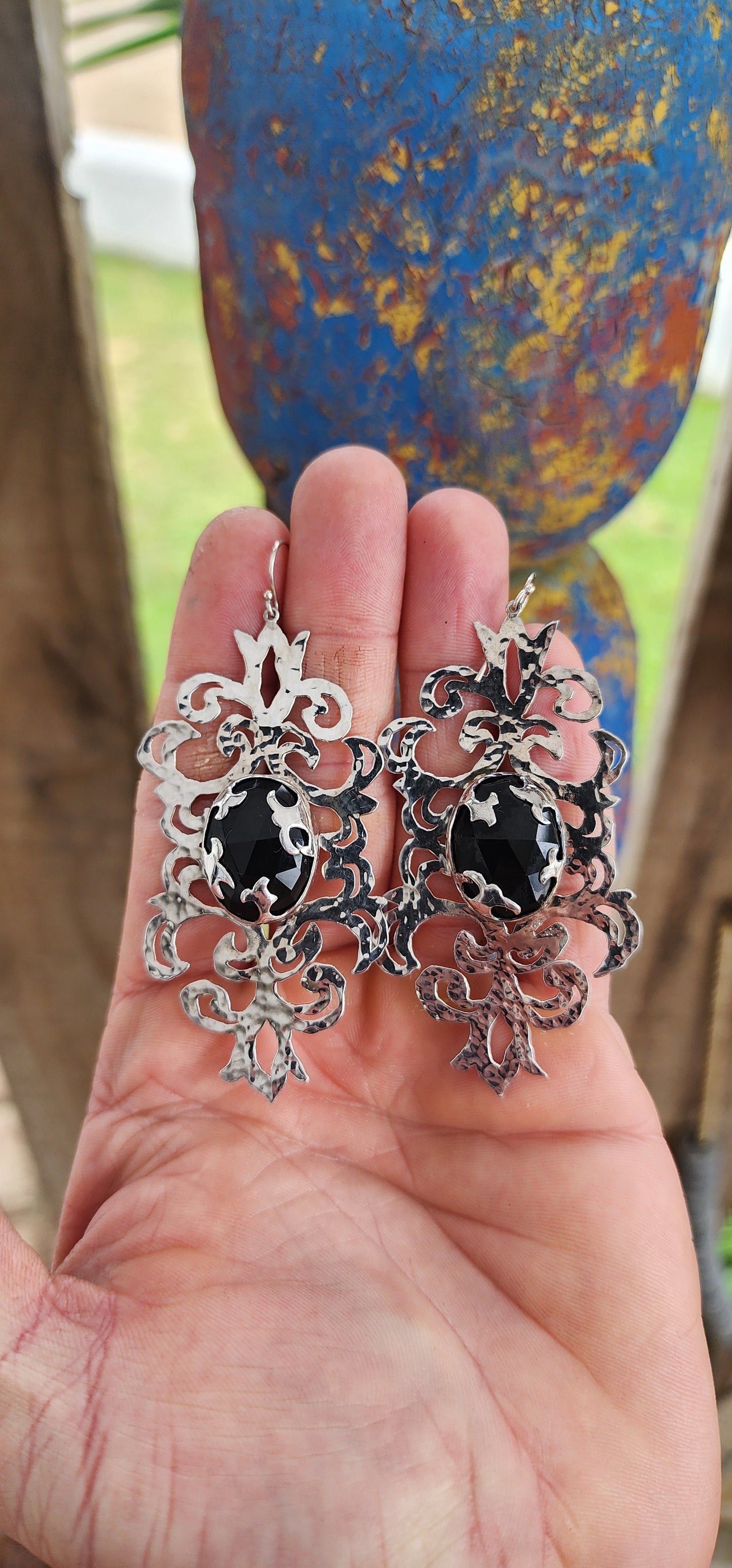 Absolutely striking and unapologetically bold — these statement earrings are a celebration of intricate craftsmanship and gothic elegance, brought to life by the acclaimed South African jewelry brand Topiary and Ashe.