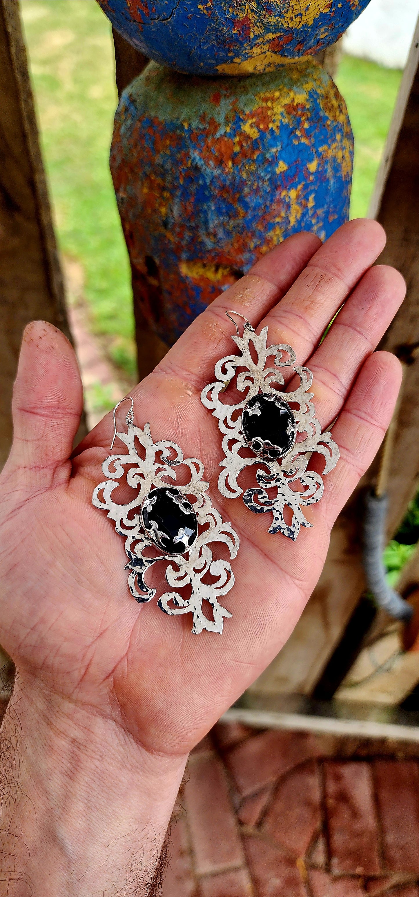 Absolutely striking and unapologetically bold — these statement earrings are a celebration of intricate craftsmanship and gothic elegance, brought to life by the acclaimed South African jewelry brand Topiary and Ashe.