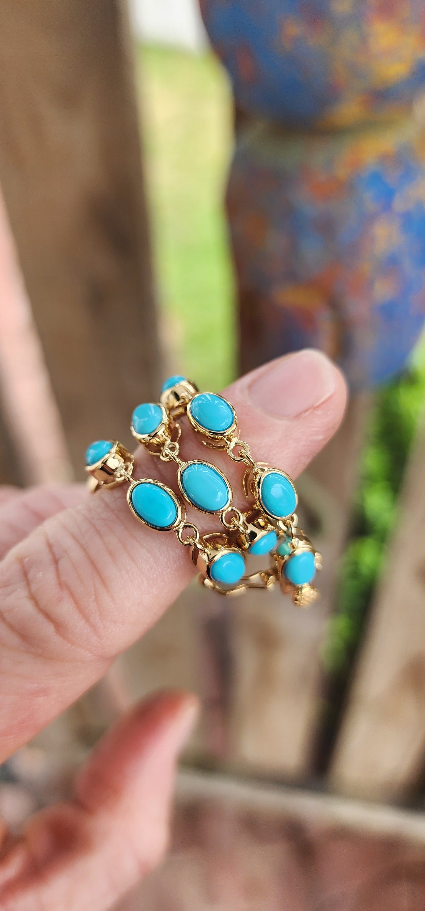 This beautiful tennis bracelet is crafted in sterling silver and finished with rich 18ct yellow gold plating, giving it a warm, luxurious glow. It features a row of 16 oval sleeping beauty turquoise cabochons.