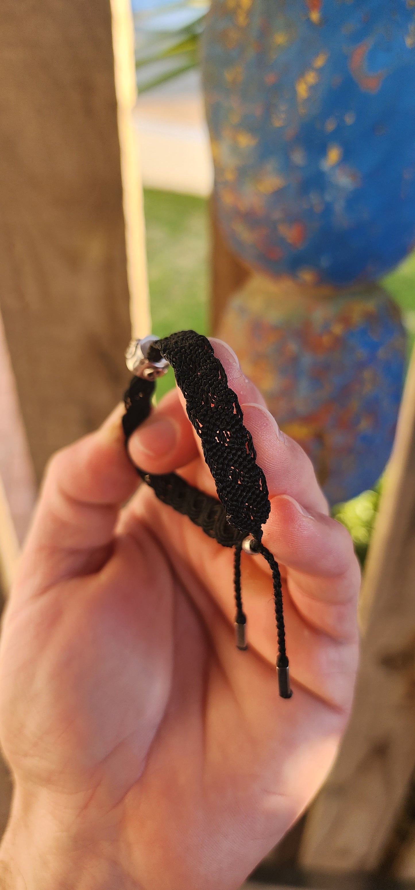 This stylish unisex P-a-n-d-o-r-a bracelet is a contemporary take on a timeless craft. Meticulously woven in rich black macramé cord, the bracelet showcases a robust and flexible structure, designed to adapt comfortably to a variety of wrist sizes.