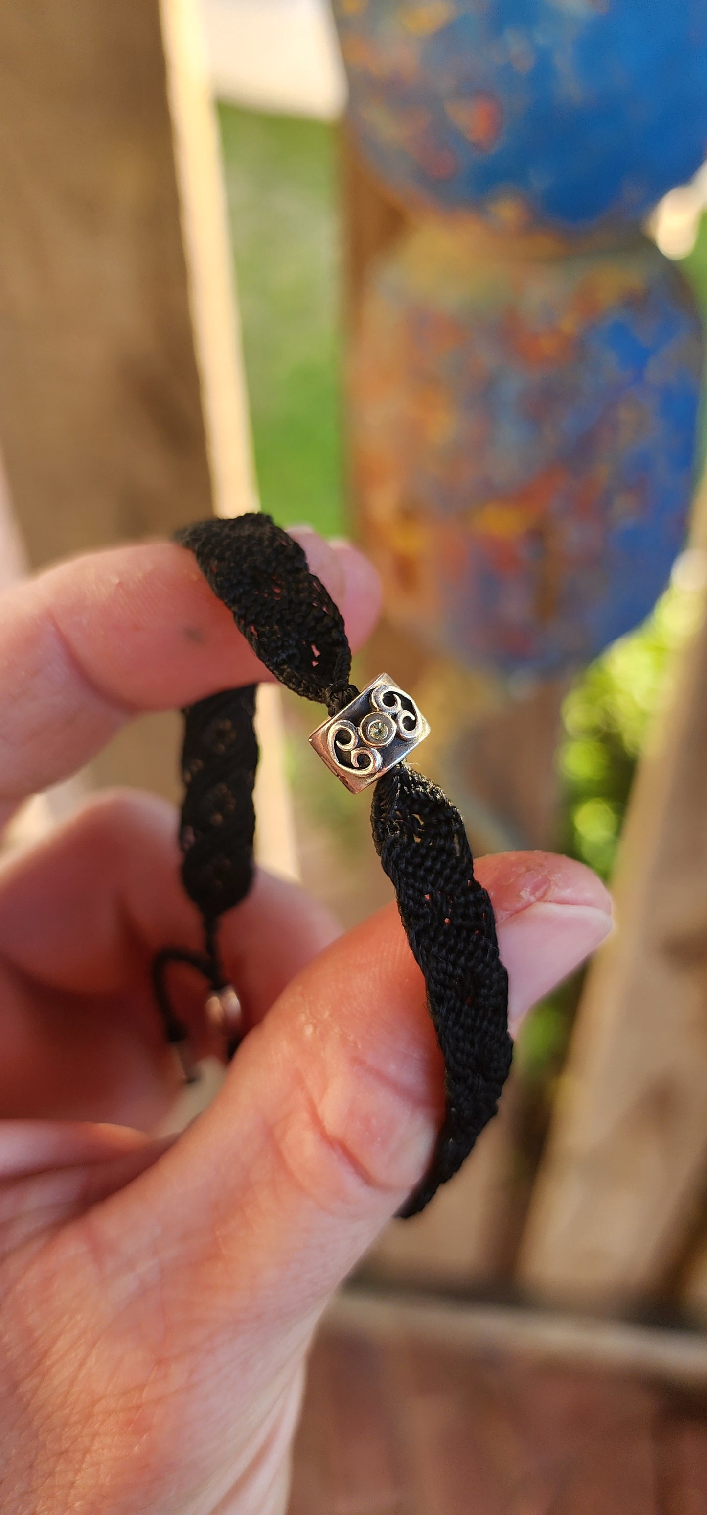 This stylish unisex P-a-n-d-o-r-a bracelet is a contemporary take on a timeless craft. Meticulously woven in rich black macramé cord, the bracelet showcases a robust and flexible structure, designed to adapt comfortably to a variety of wrist sizes.