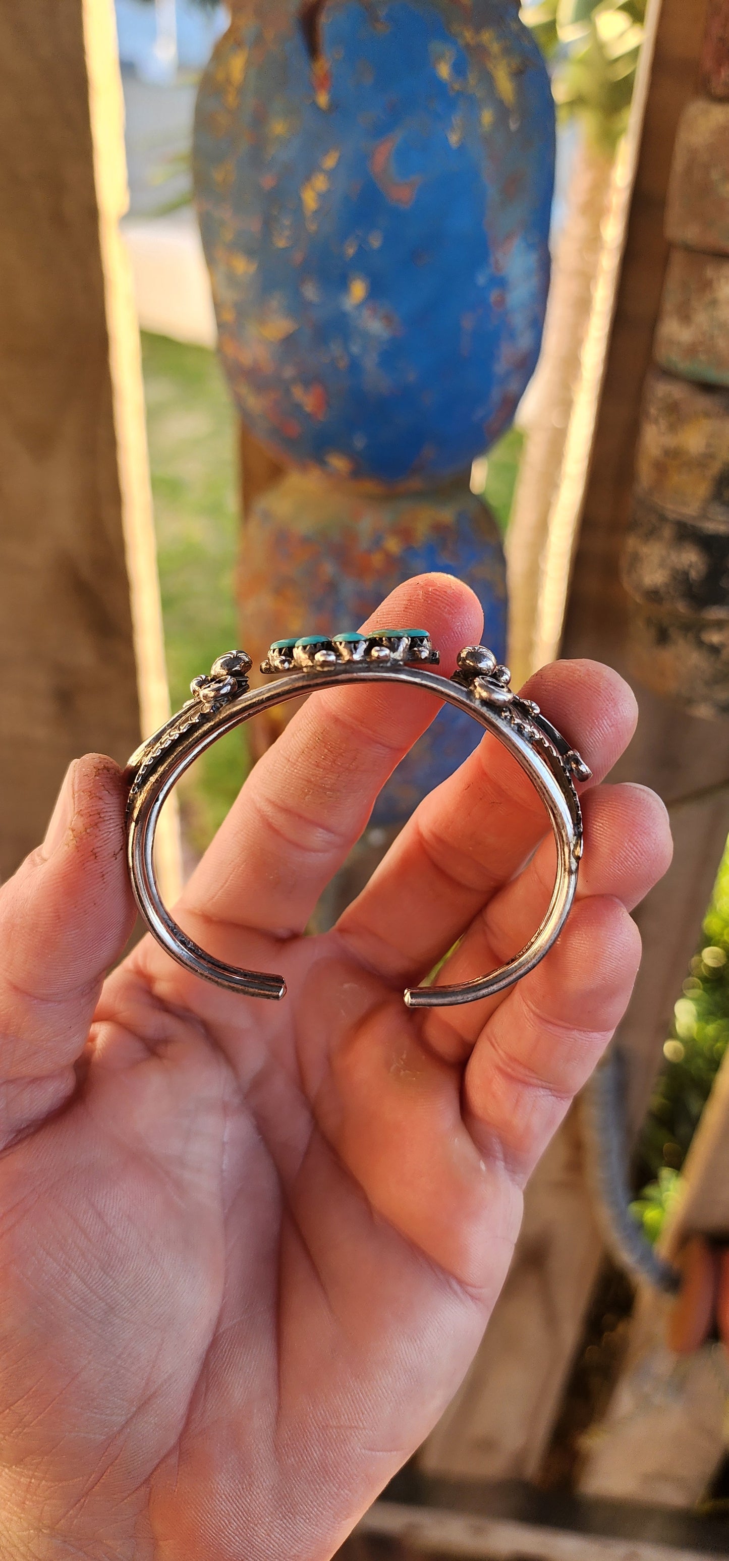 This striking and chunky vintage Southwestern Navajo-style cuff bracelet is a bold testament to both artistry and heritage. Forged in sterling silver, the cuff’s structure is composed of split double bands, giving it a powerful yet airy presence.
