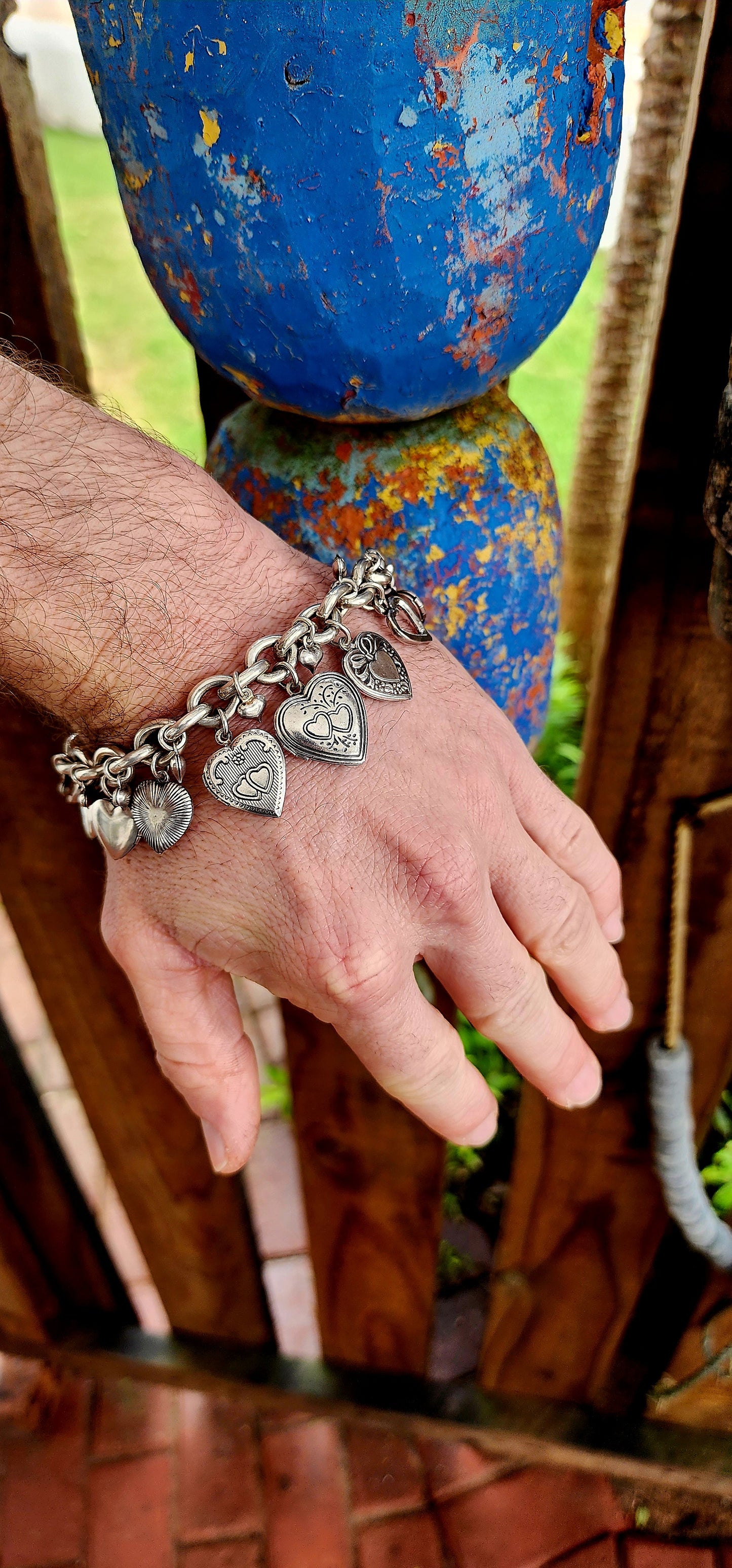 Exquisite designer costume charm bracelet by the celebrated French house Gas Bijoux. Crafted with a substantial silver-plated oval-link chain, this bracelet is a joyful celebration of love, nostalgia, and bohemian spirit.