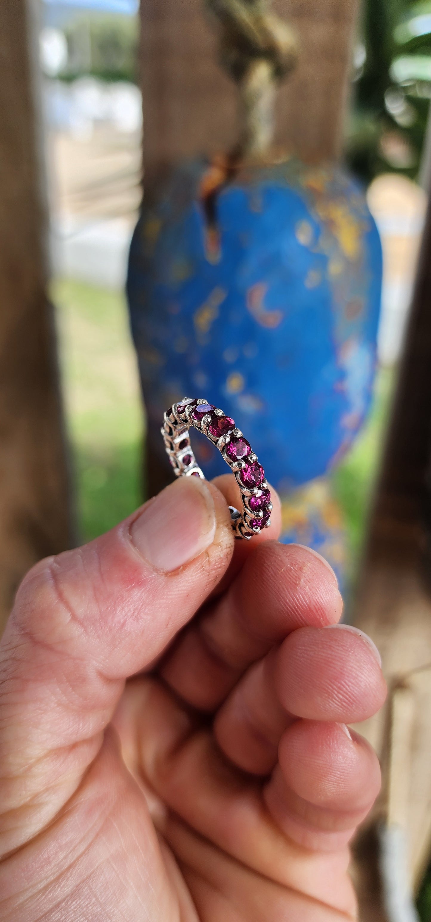 This sterling silver full eternity ring is set with 17 round-cut rhodolite garnets, each one meticulously claw-set to form an unbroken circle of luminous berry brilliance.