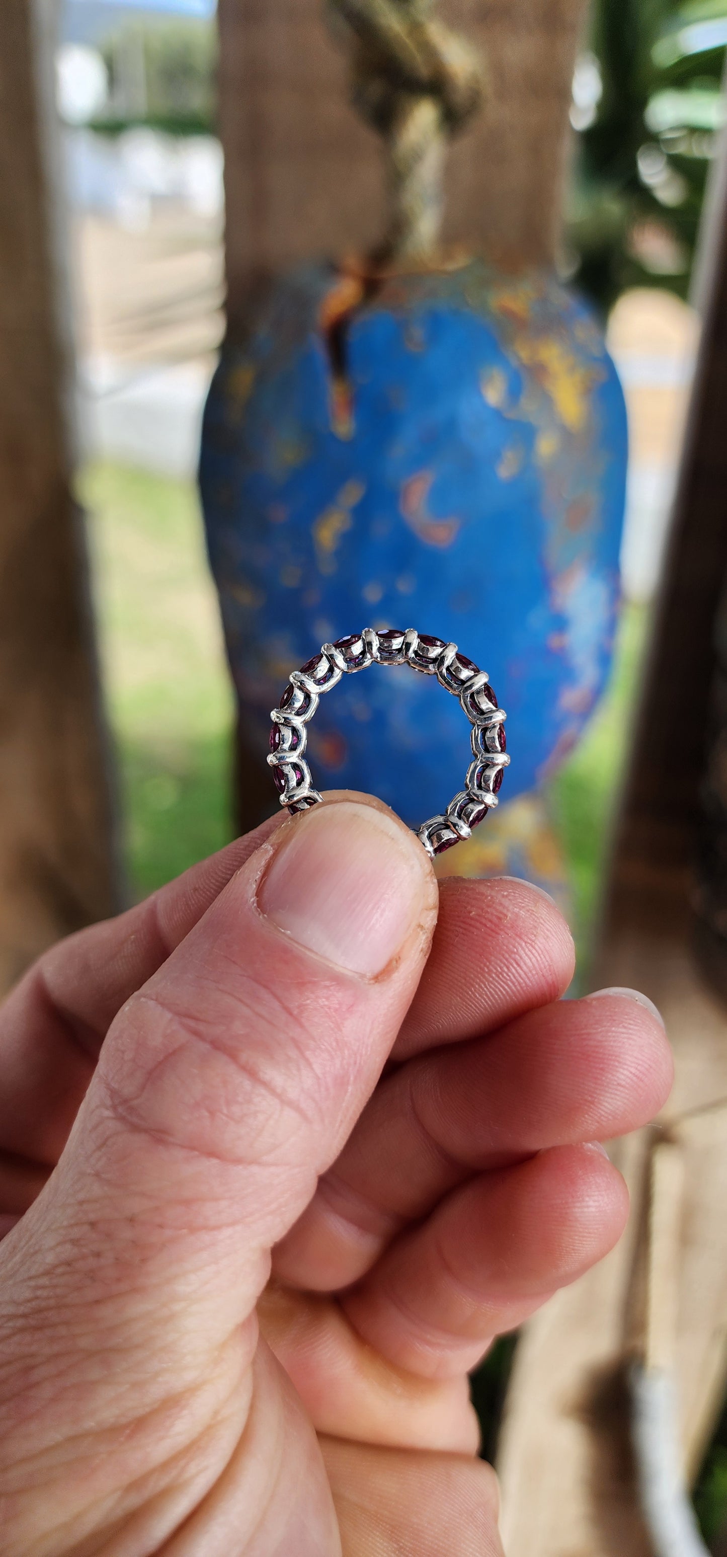 This sterling silver full eternity ring is set with 17 round-cut rhodolite garnets, each one meticulously claw-set to form an unbroken circle of luminous berry brilliance.