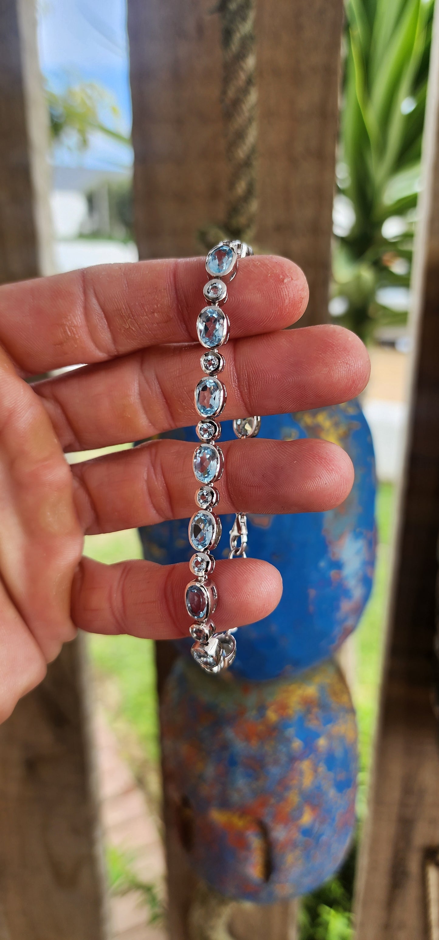 This dazzling bracelet is crafted in polished sterling silver, showcasing a graceful row of 24x sky blue topaz gemstones, each securely nestled in sleek tube bezel settings.
